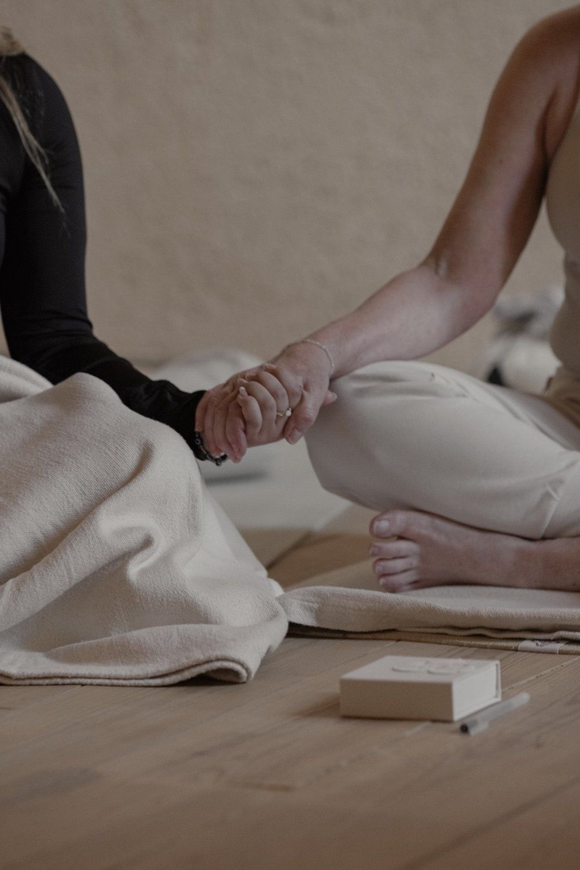 Hands are intertwined, showing support and connection.