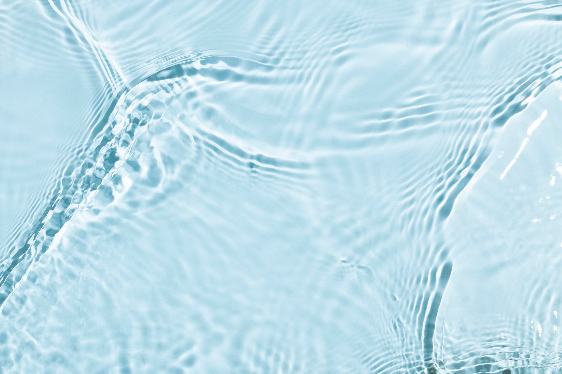 A blue swimming pool with clear blue water