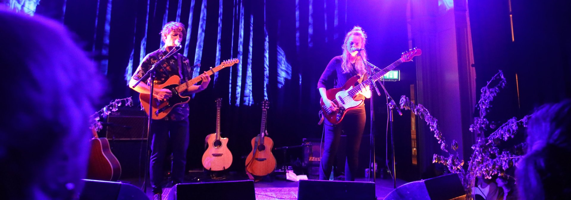 an abstract photo of a curved building with a blue sky in the background