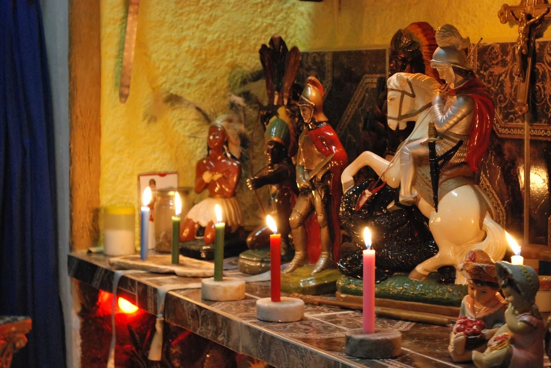 couple sitting on brown sand near body of water during daytime