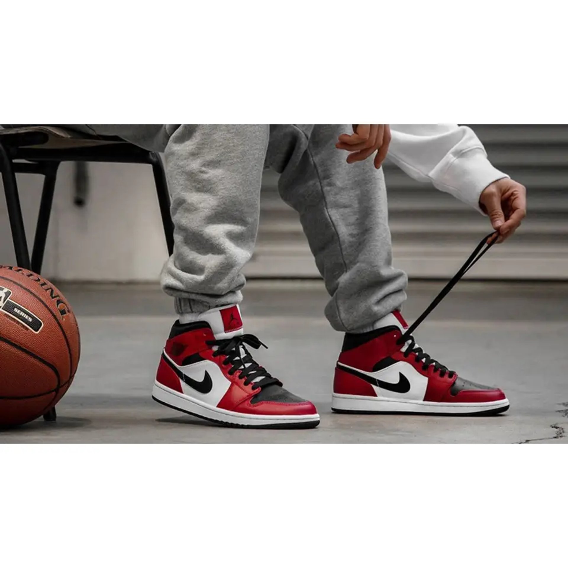 Air Jordan 1 Mid 'Chicago Black Toe' sneakers in black, white, and red with high-top design and Nike Swoosh