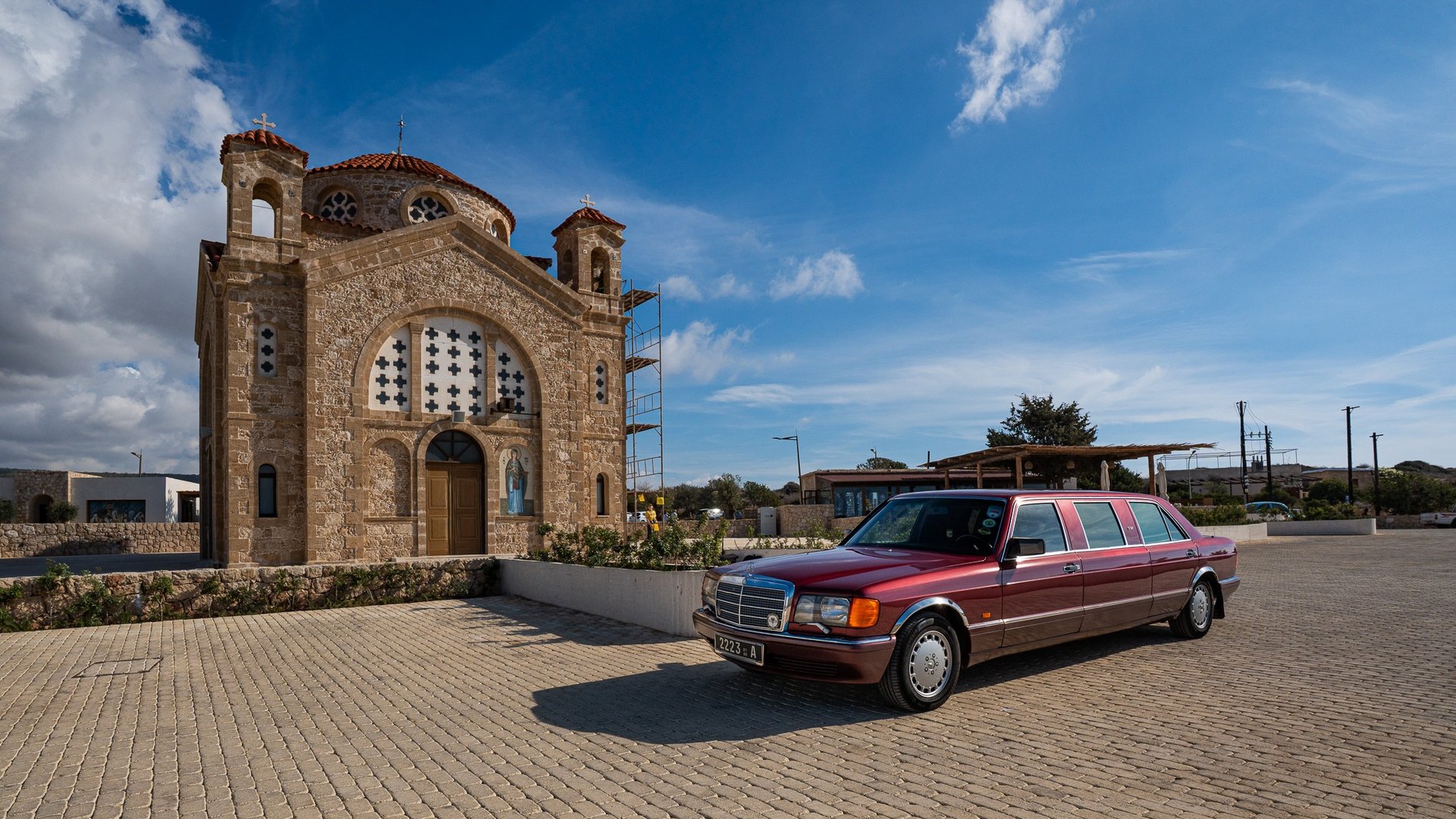 woman wearing yellow long-sleeved dress under white clouds and blue sky during daytime