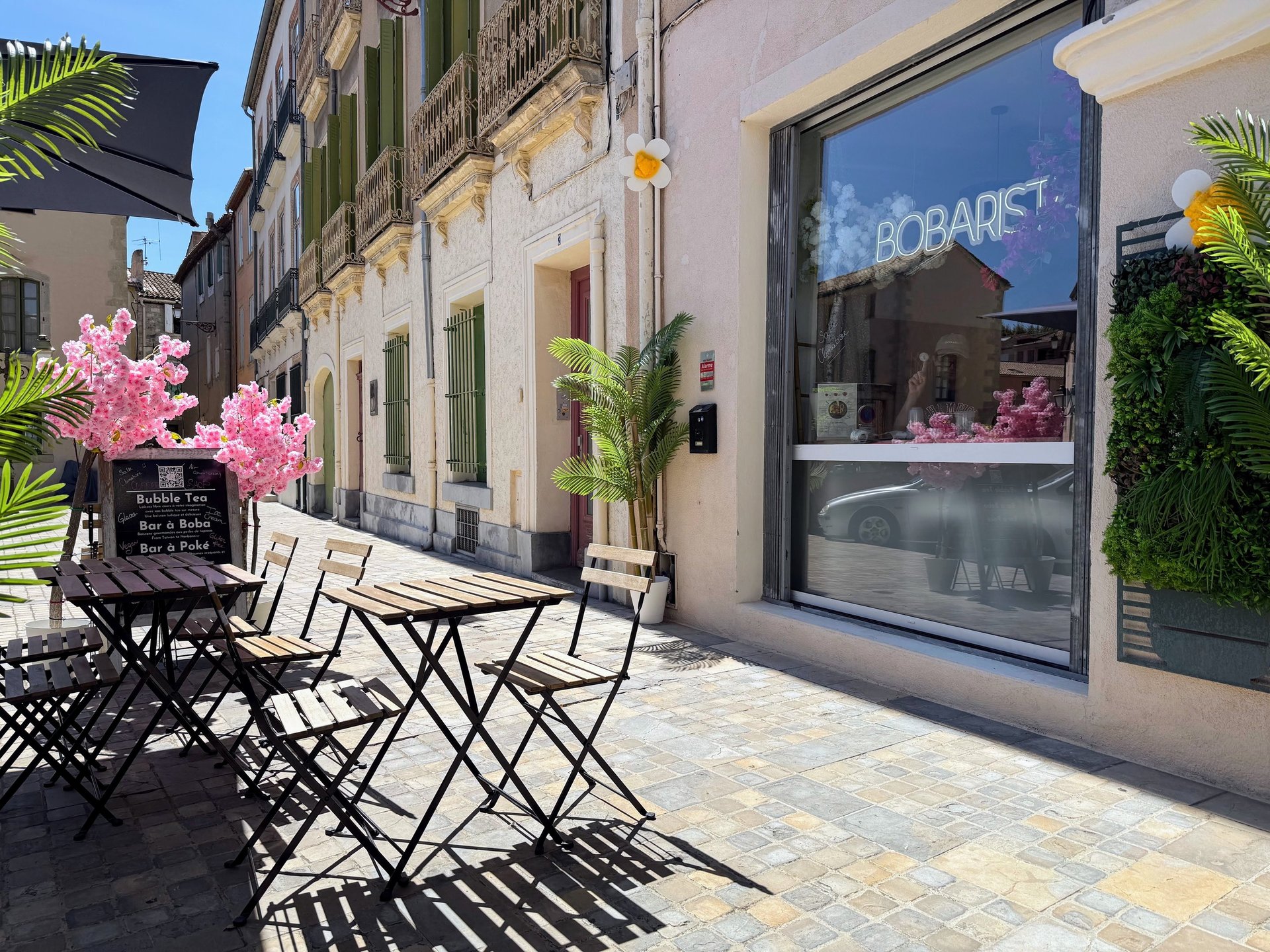 person pouring white liquid on white ceramic mug