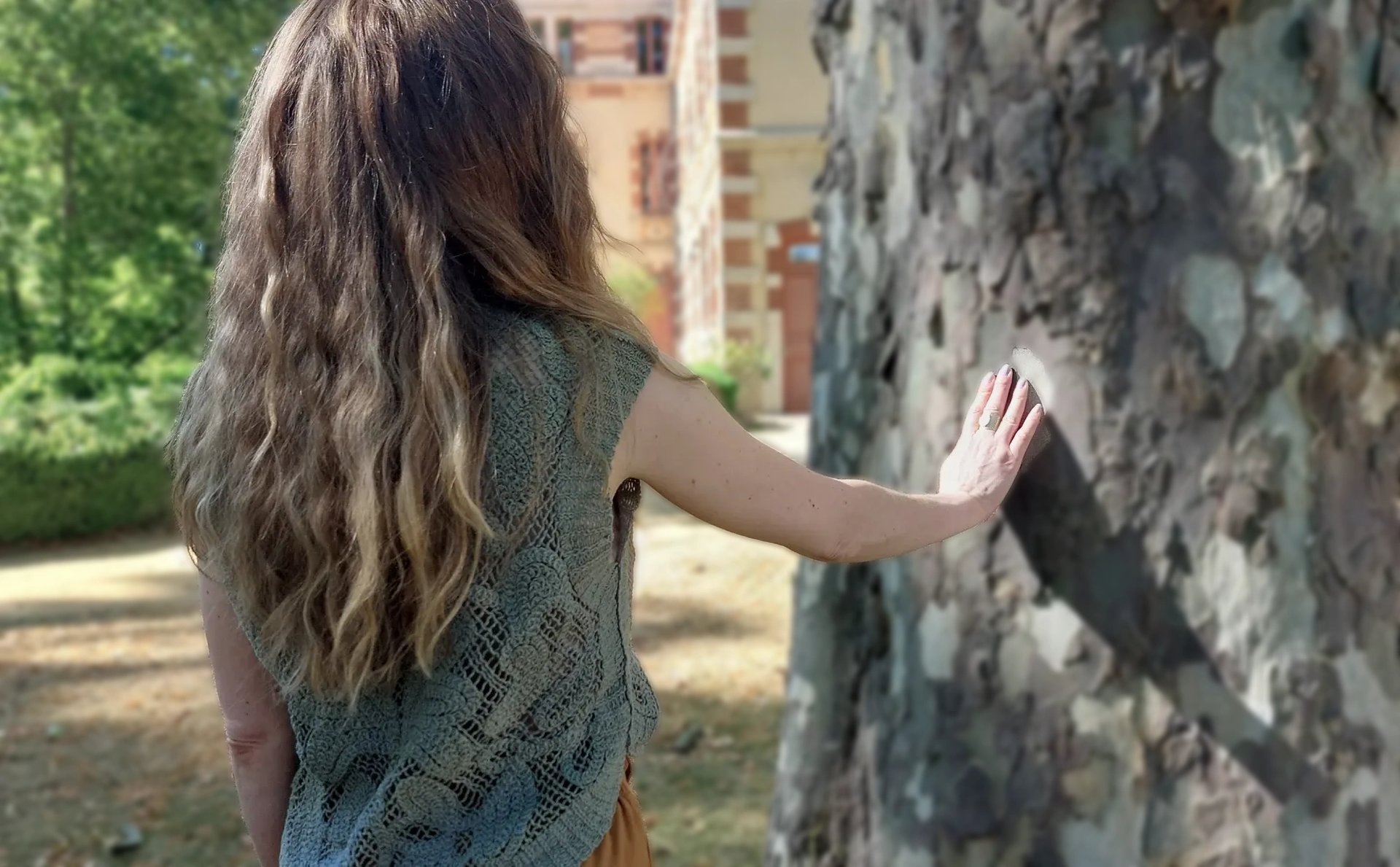 woman surrounded by Boston ferns