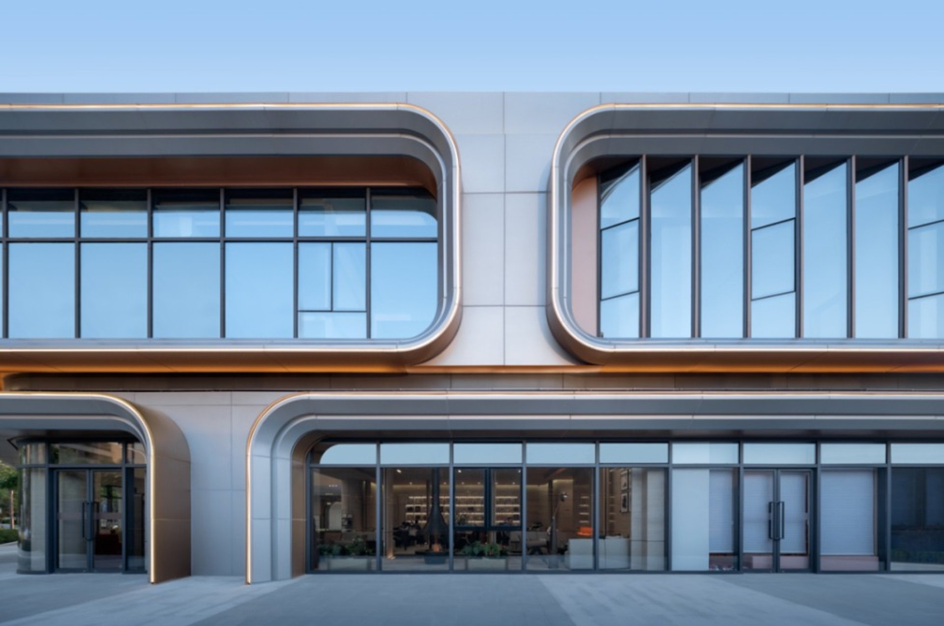 an abstract photo of a curved building with a blue sky in the background