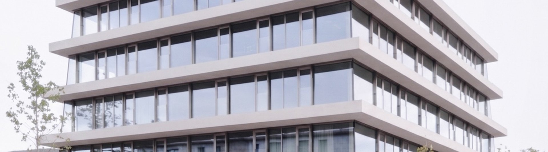 an abstract photo of a curved building with a blue sky in the background