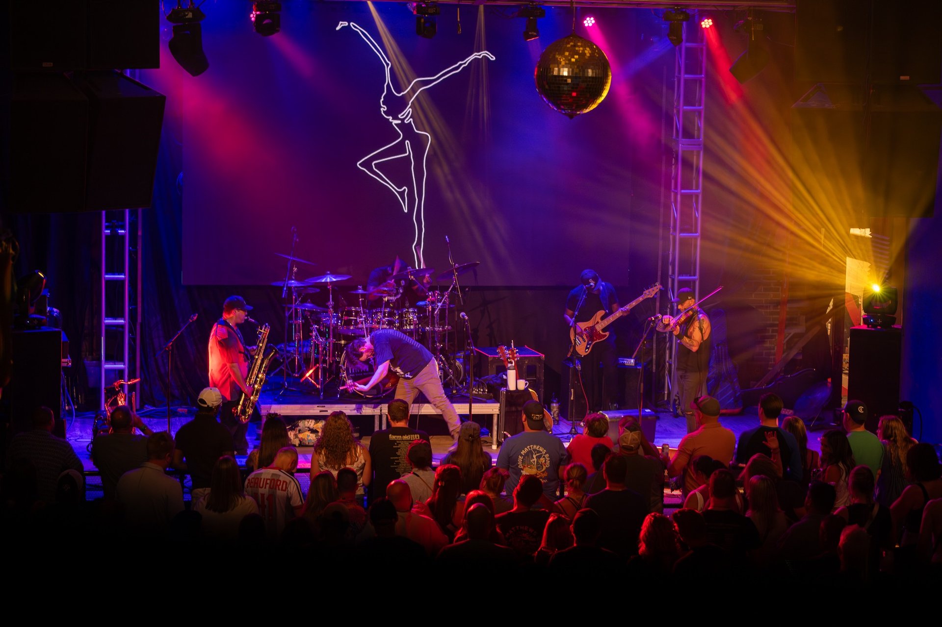 an abstract photo of a curved building with a blue sky in the background