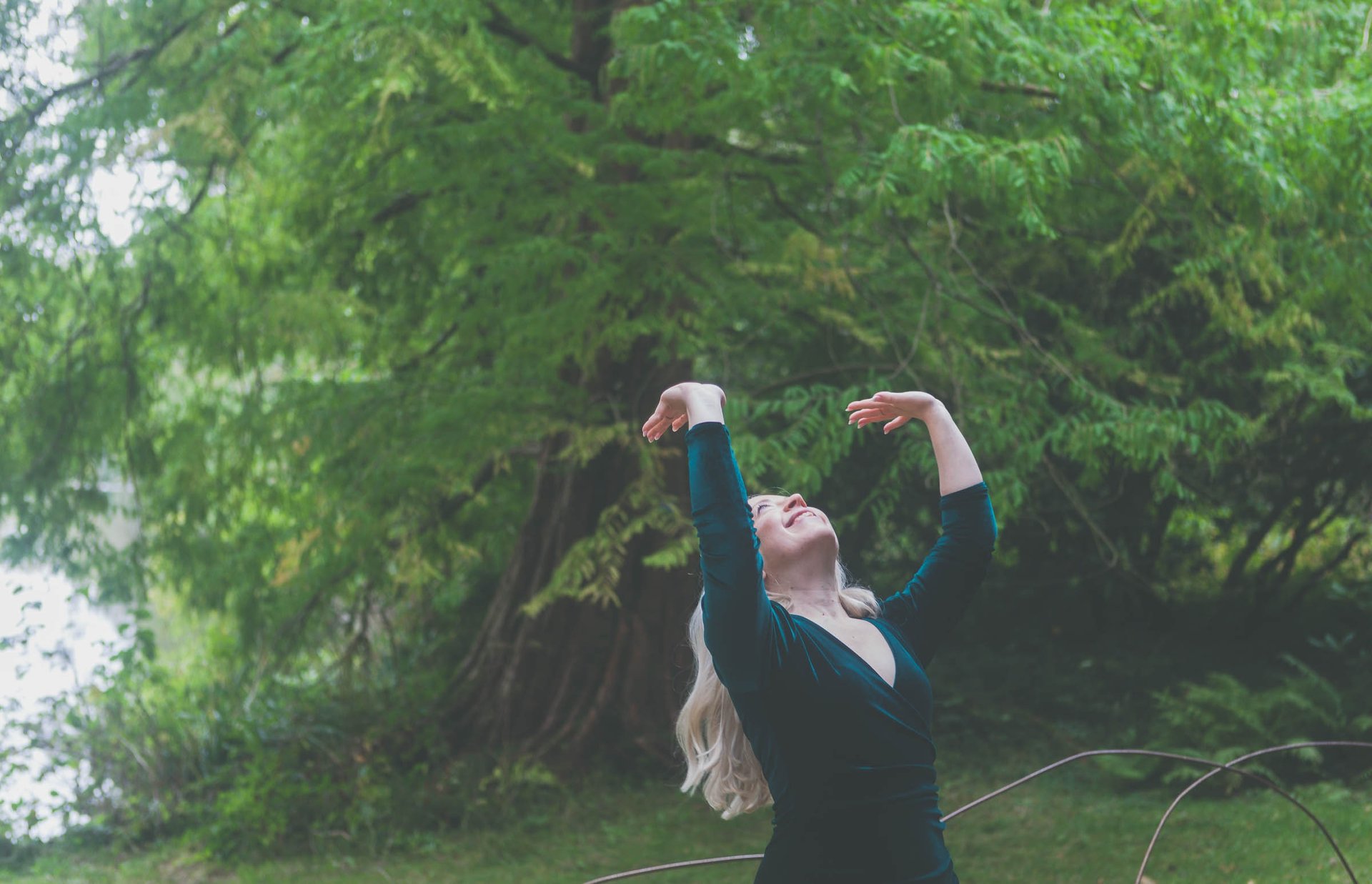 girl sitting on daisy flowerbed in forest