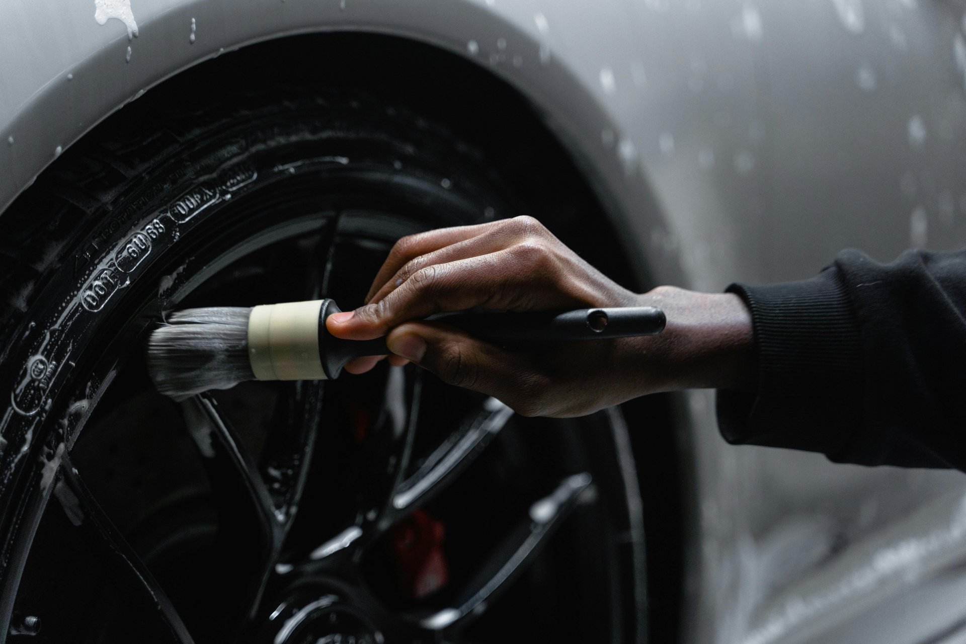 a man with a glove on his hand is changing the tire of a car