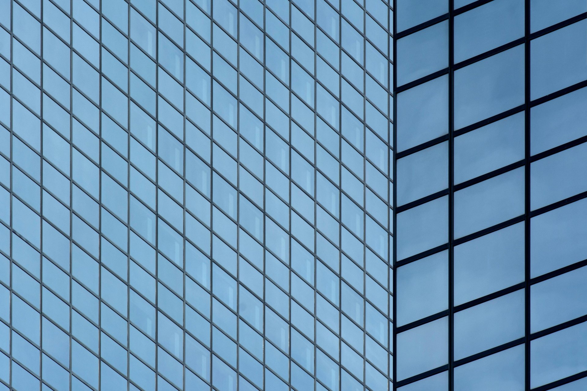 an abstract photo of a curved building with a blue sky in the background