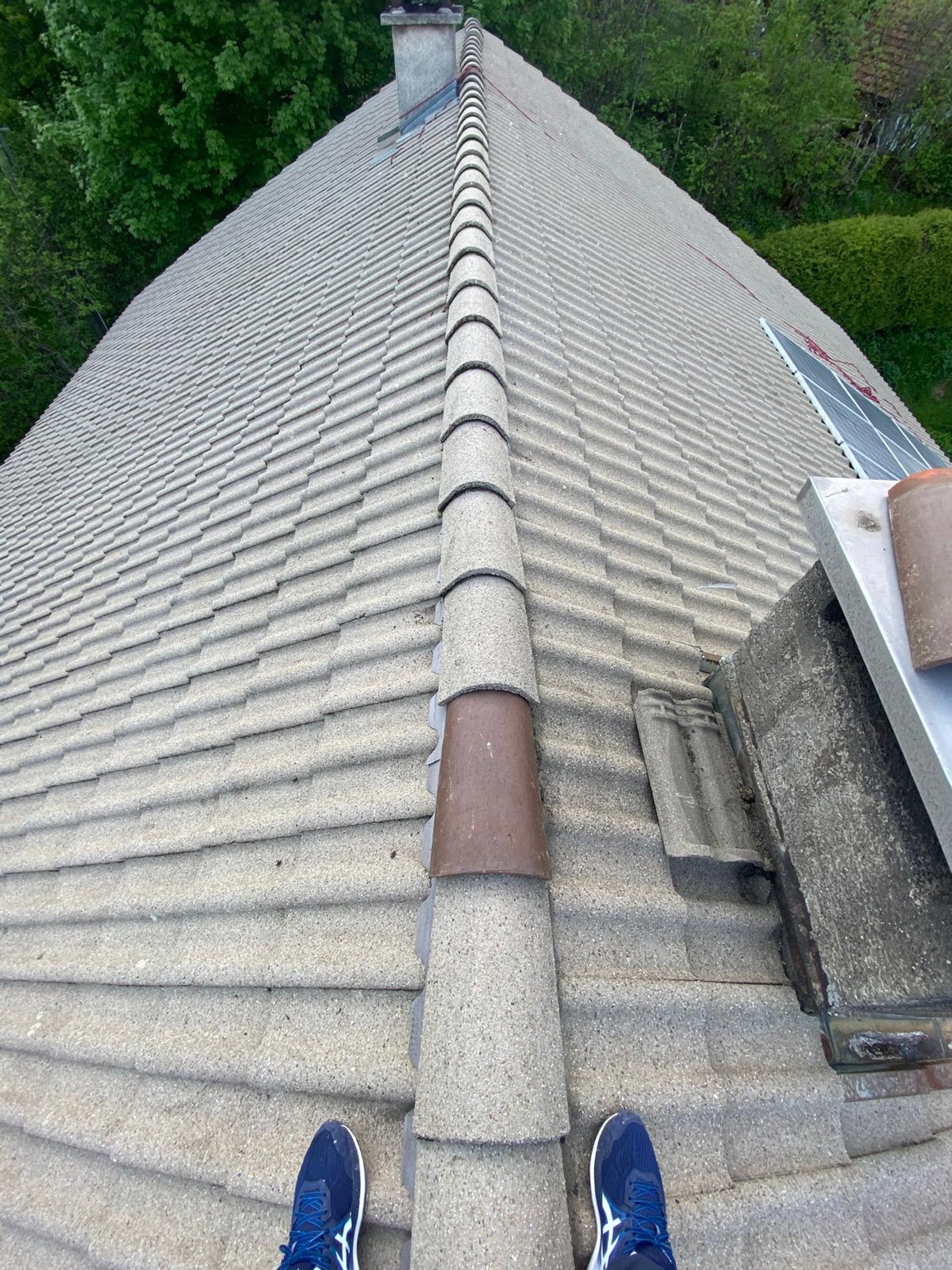 a person wearing blue gloves and holding a hammer