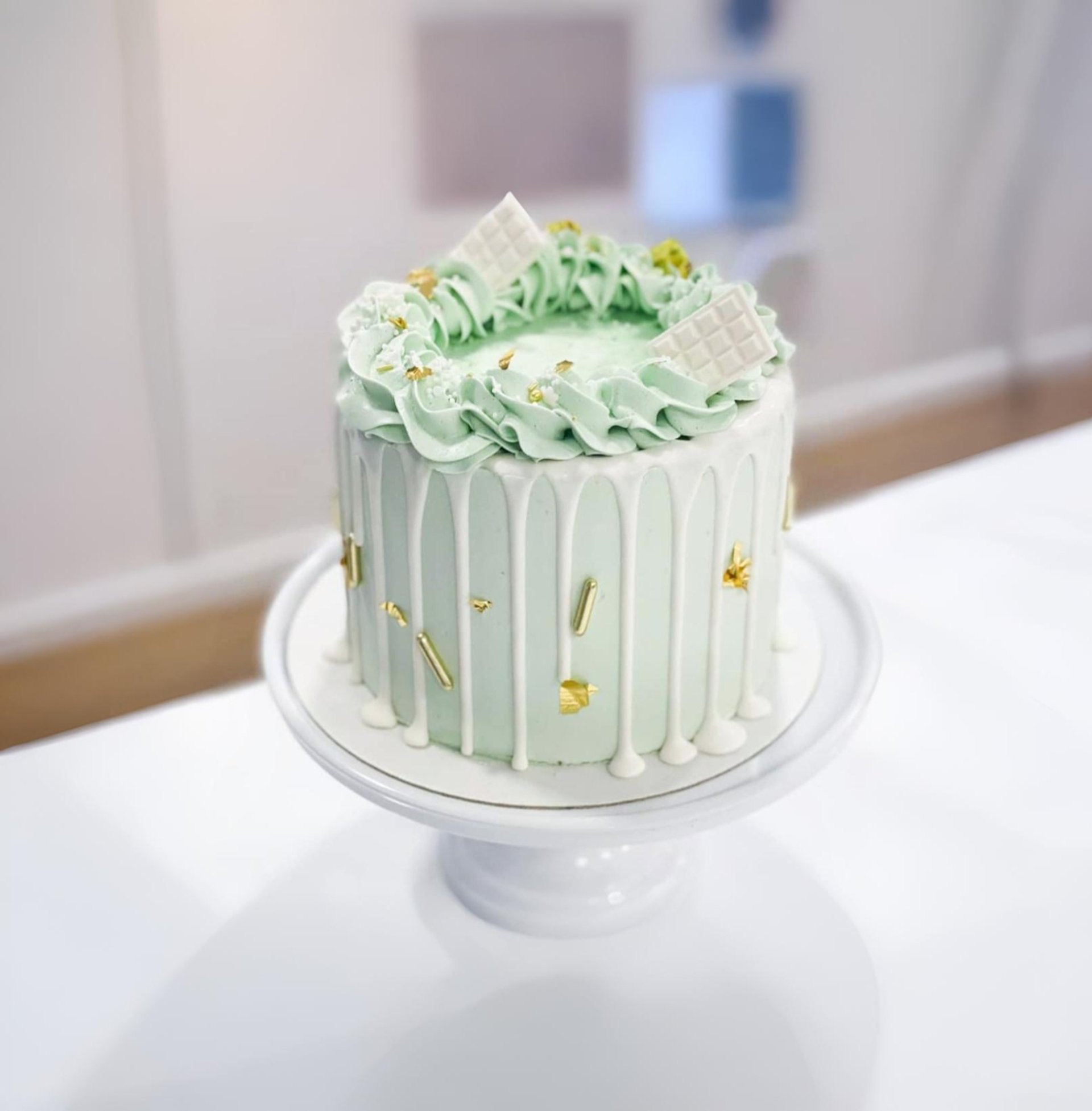 A donut cake stands tall on a blue table.