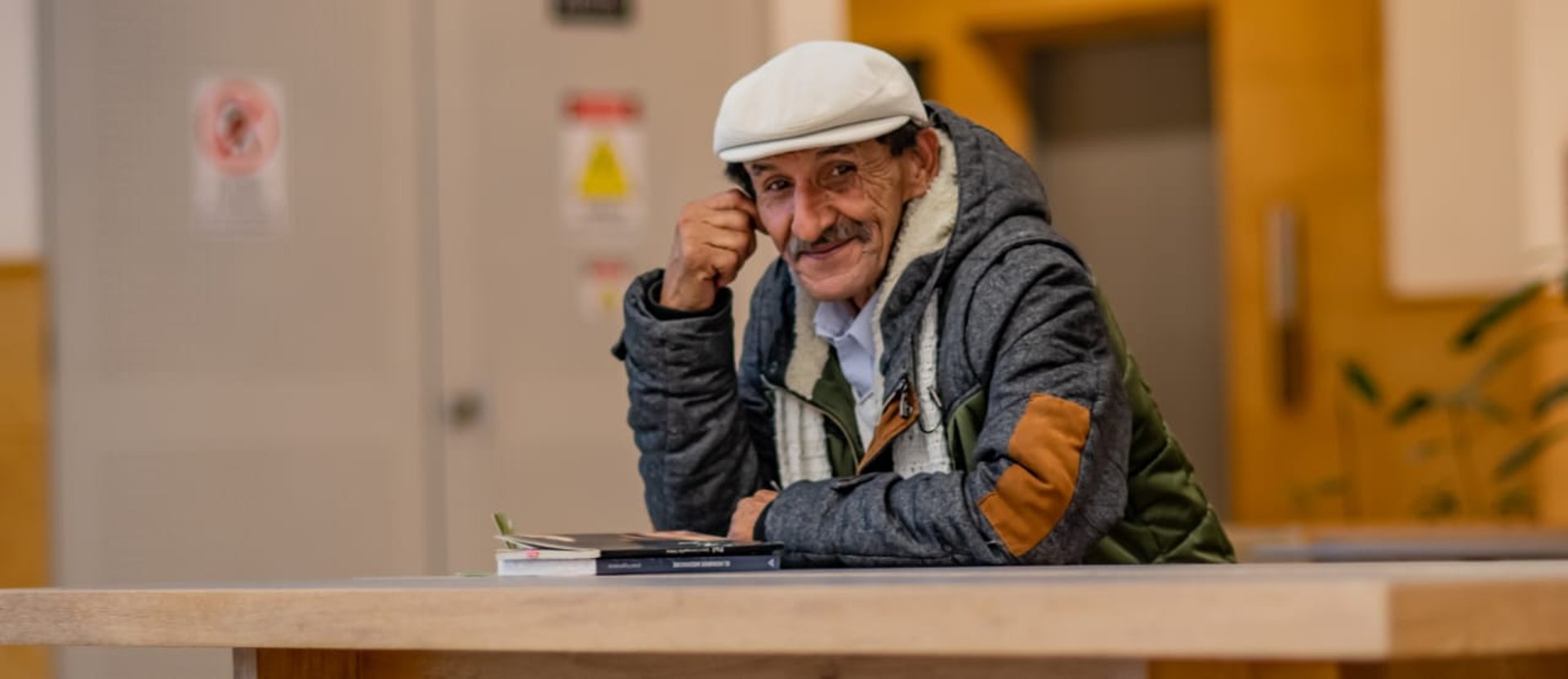 A quill pen rests on an old leather-bound book.