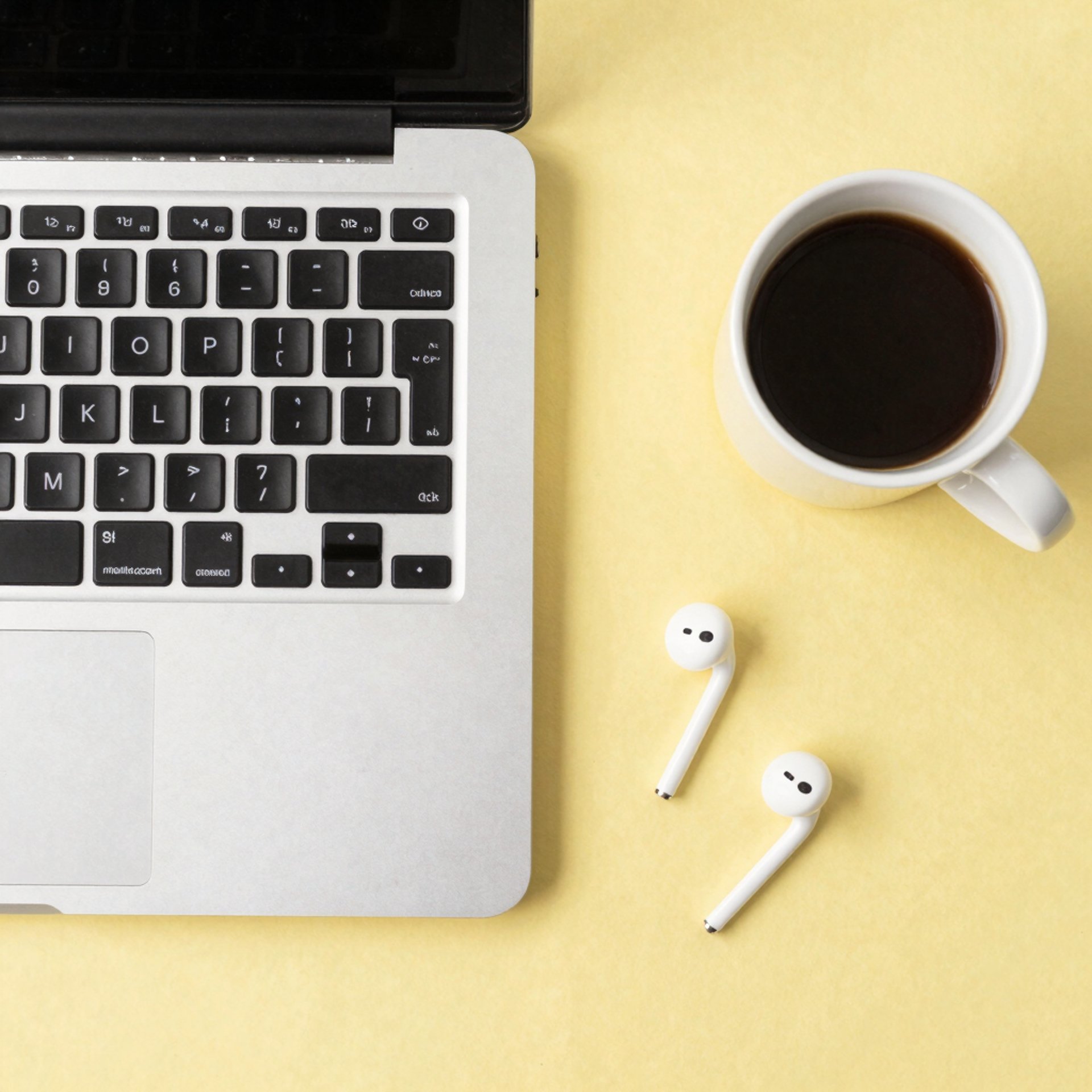 A cup of cofee and a laptop on a desk
