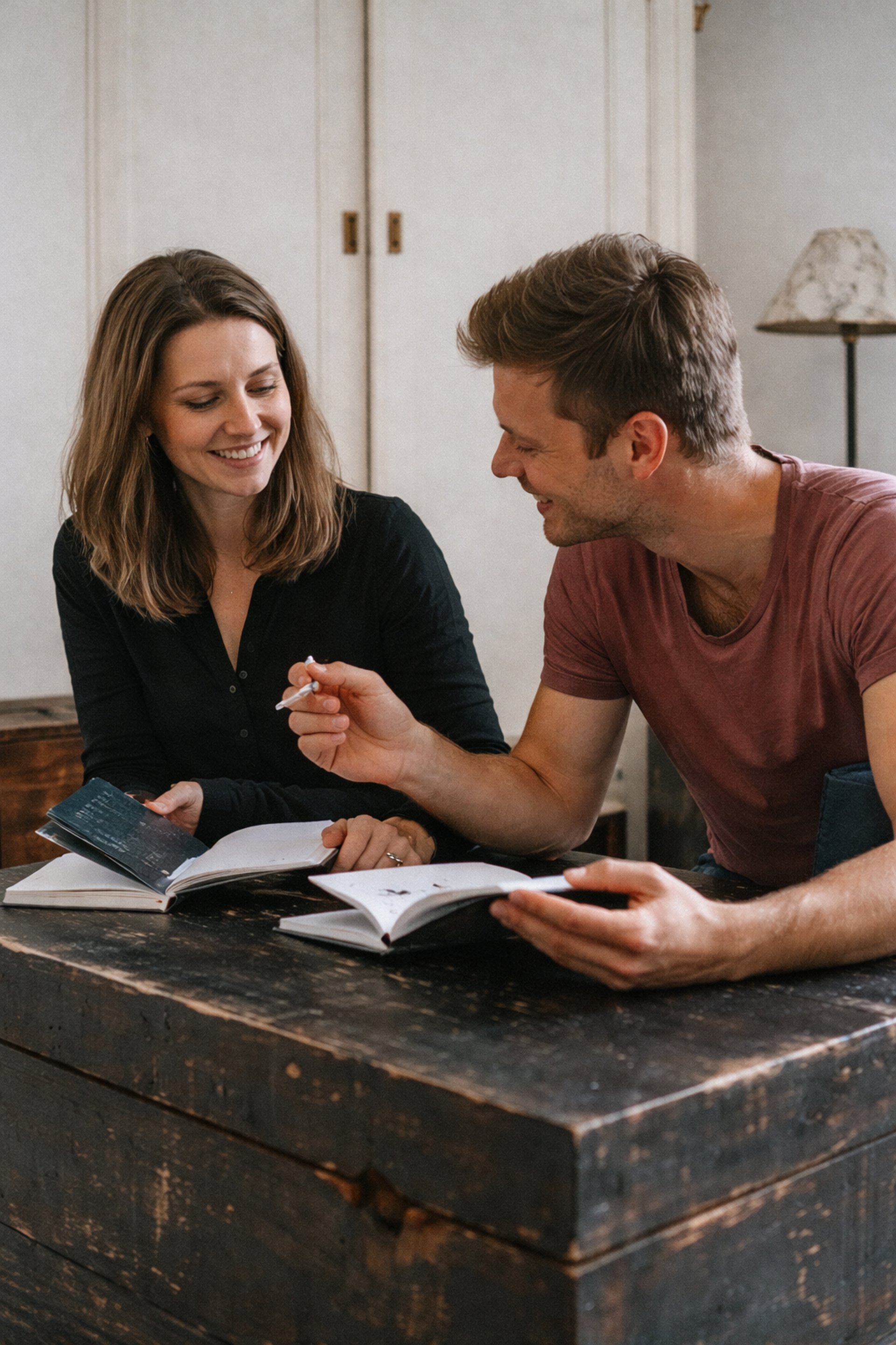 woman in blue t-shirt sitting beside woman in brown t-shirt