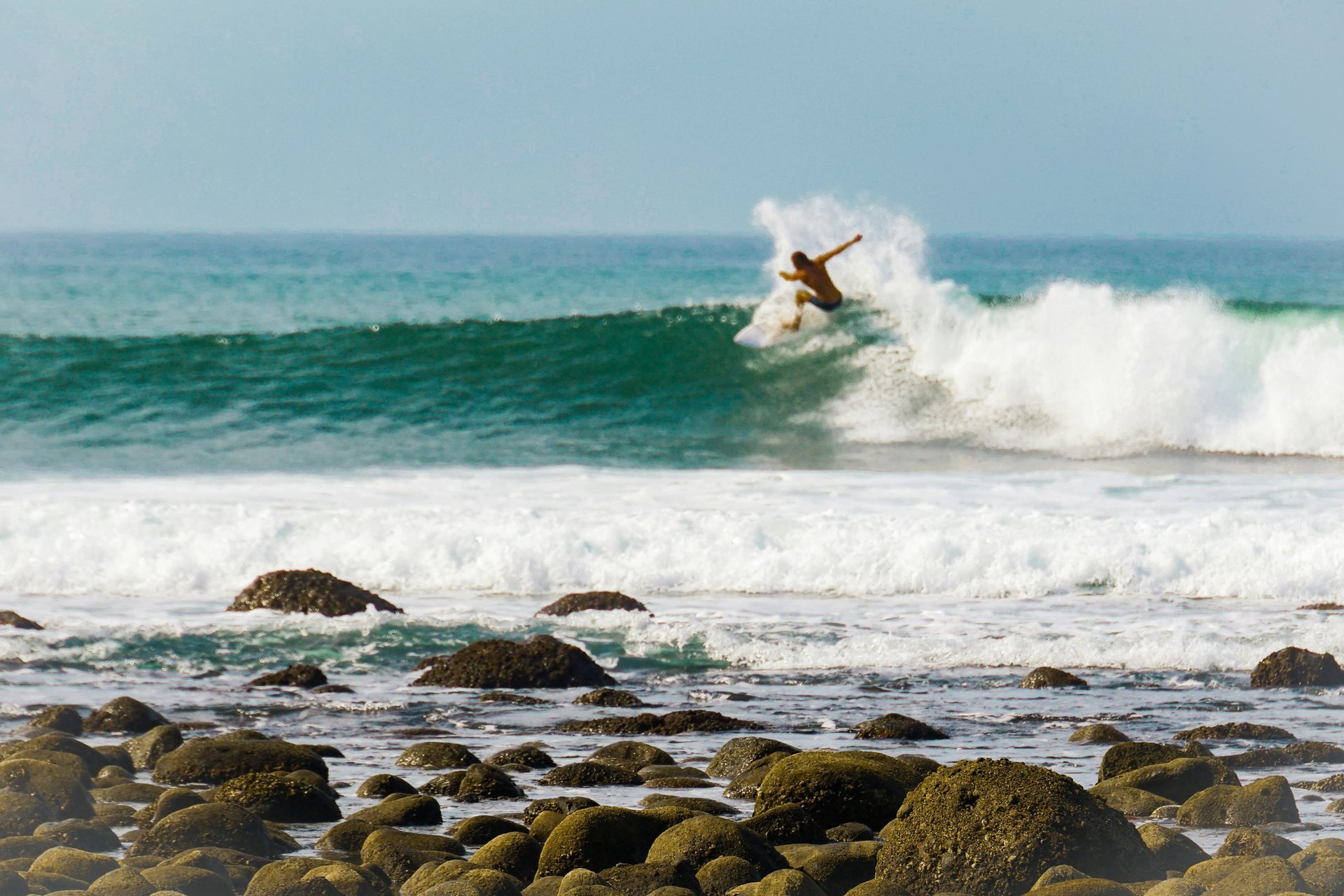 a person surfing on a wave
