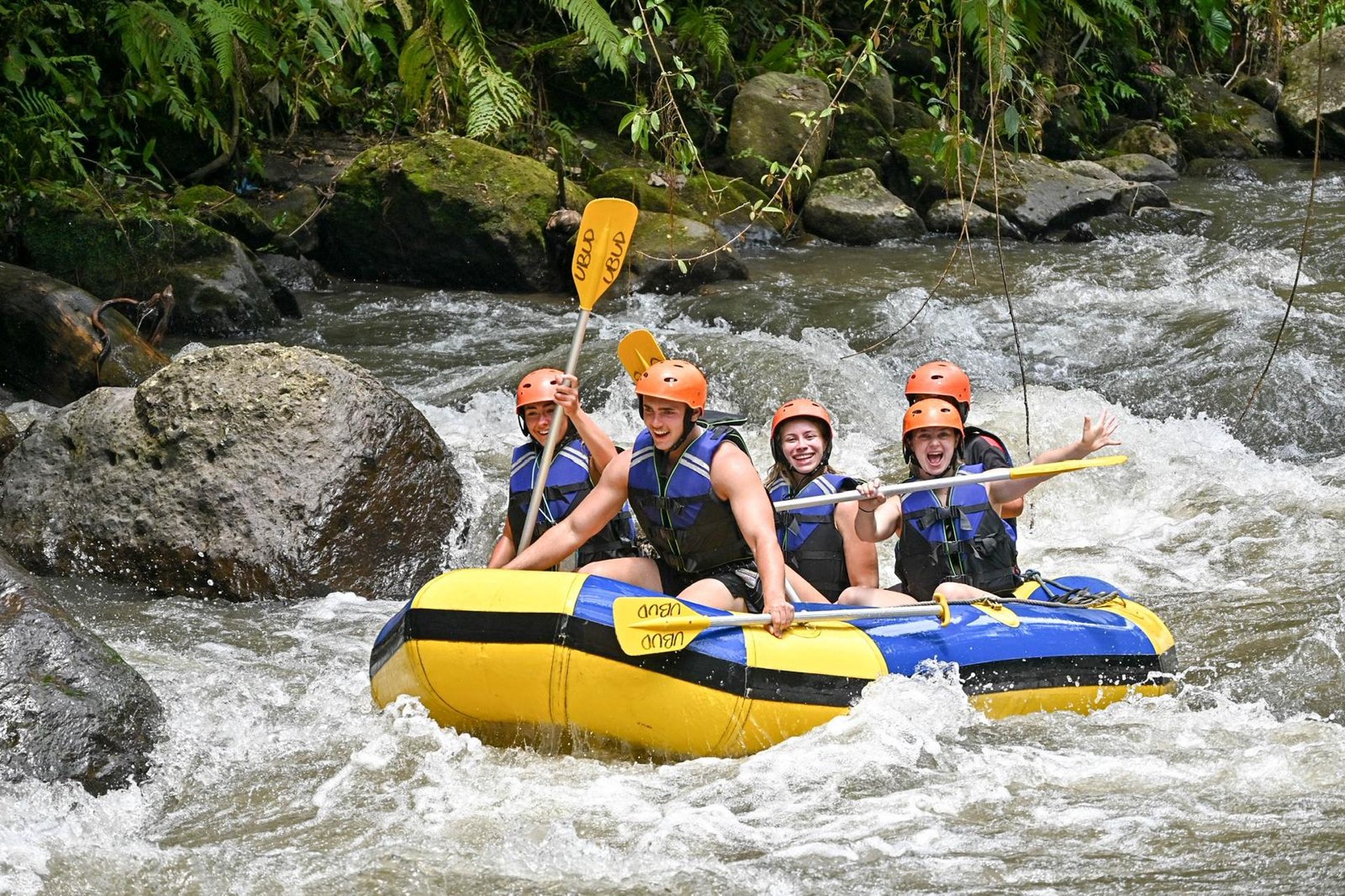 a group of people riding on top of a raft down a river