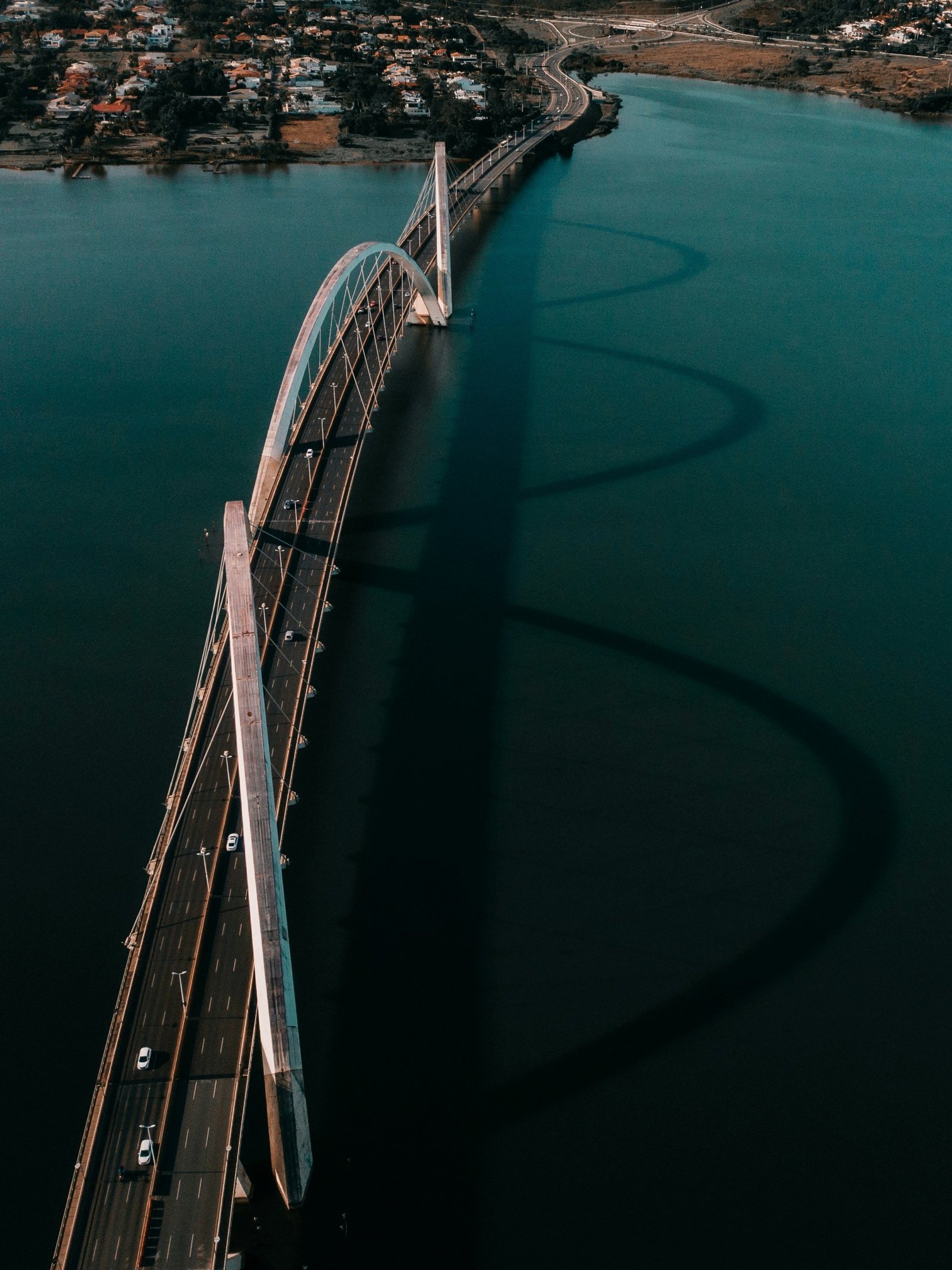 white and blue bridge over blue sea during daytime