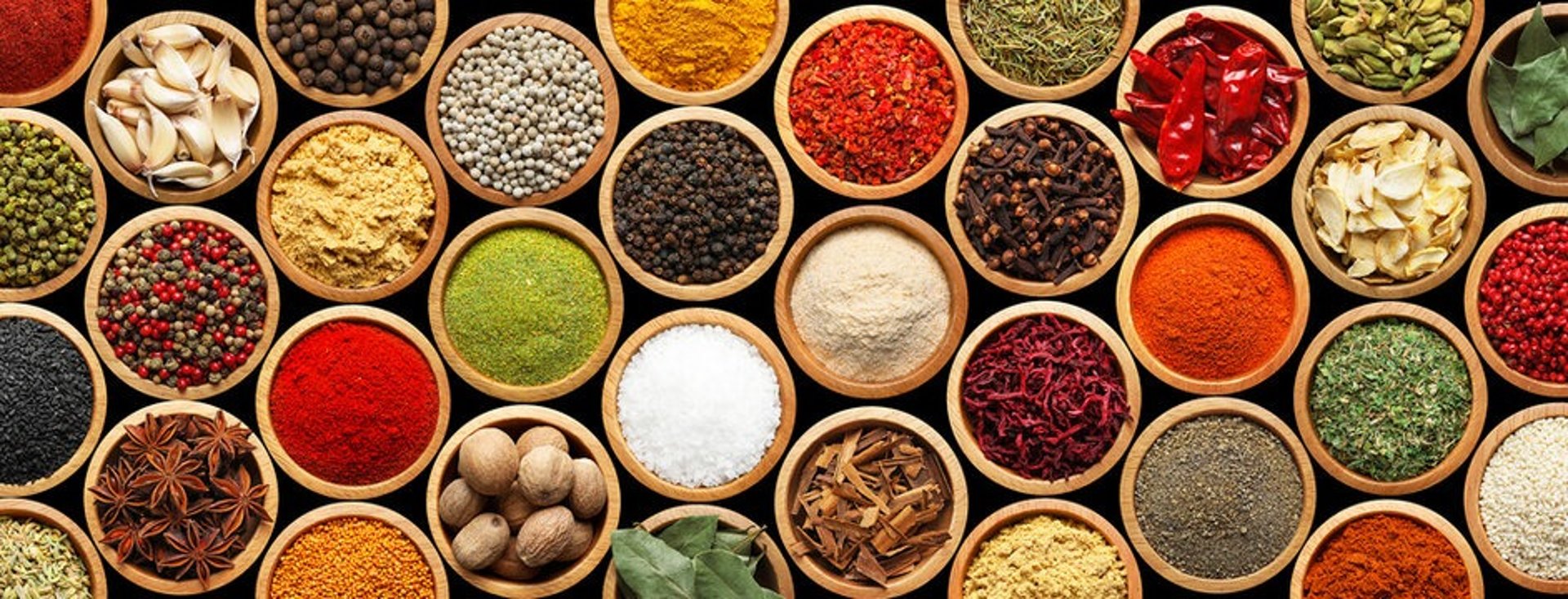a variety of spices on a white table