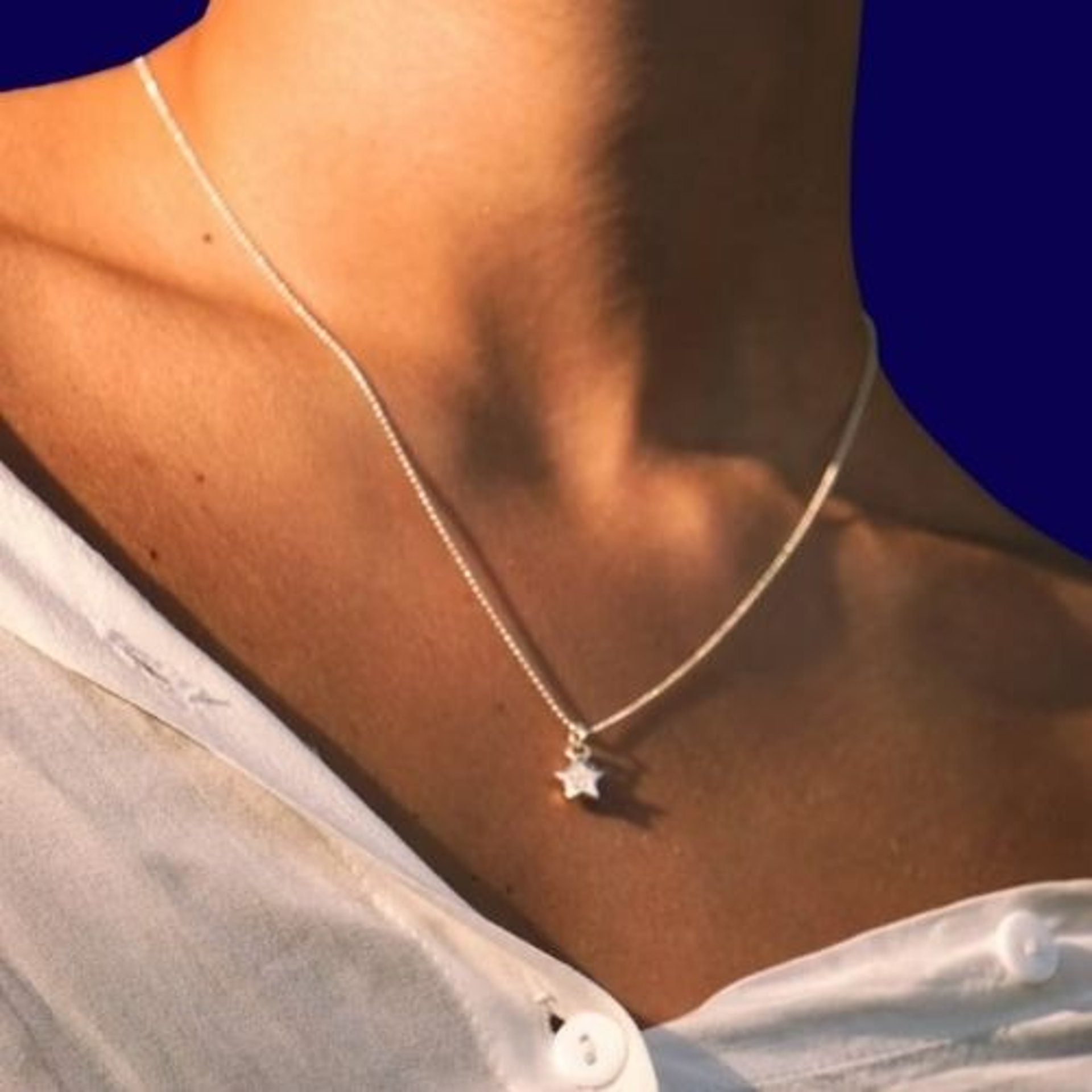 a close up of a woman wearing a necklace