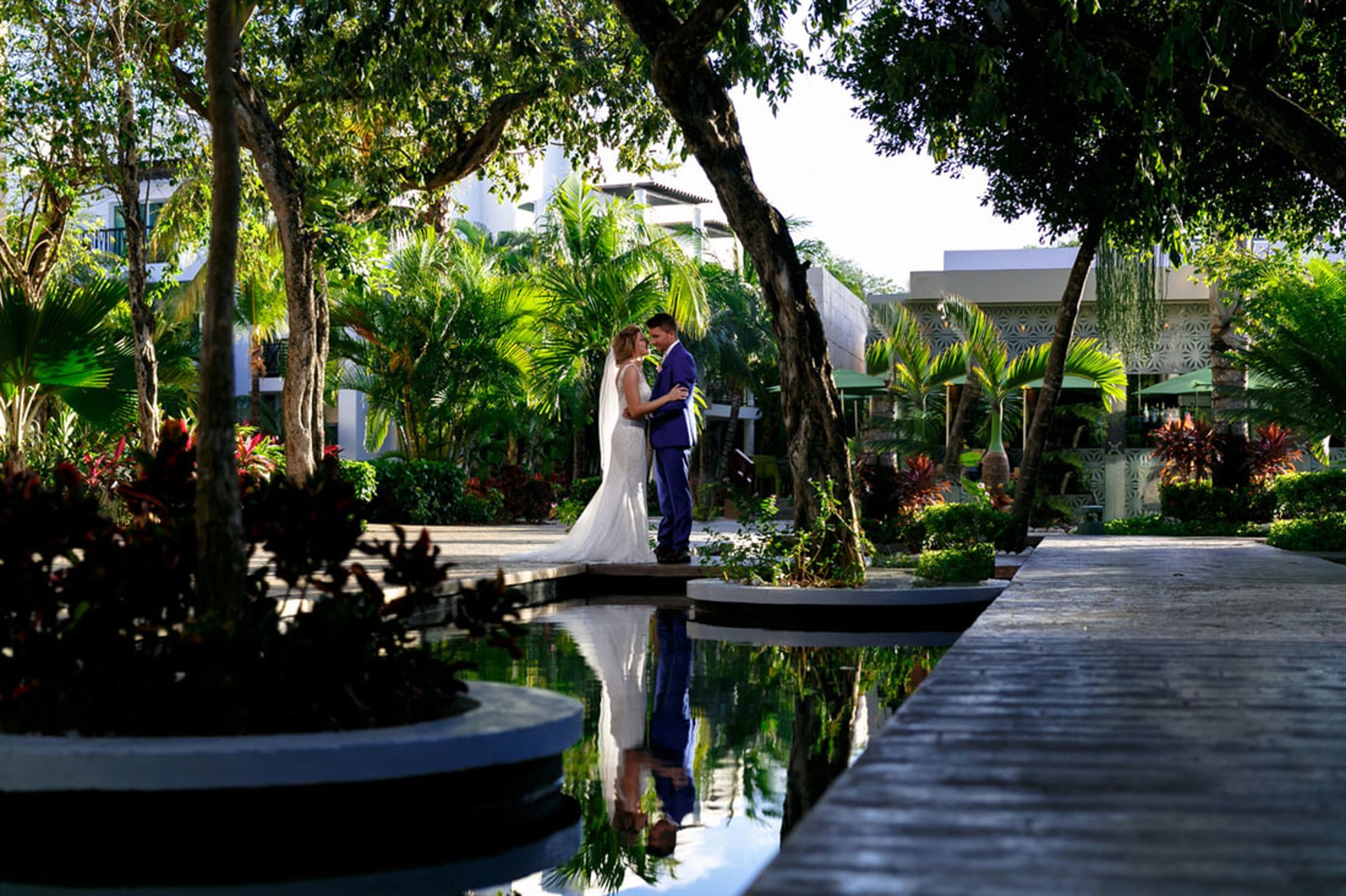Destination wedding couple pose in plaza at The Fives Beach Resort