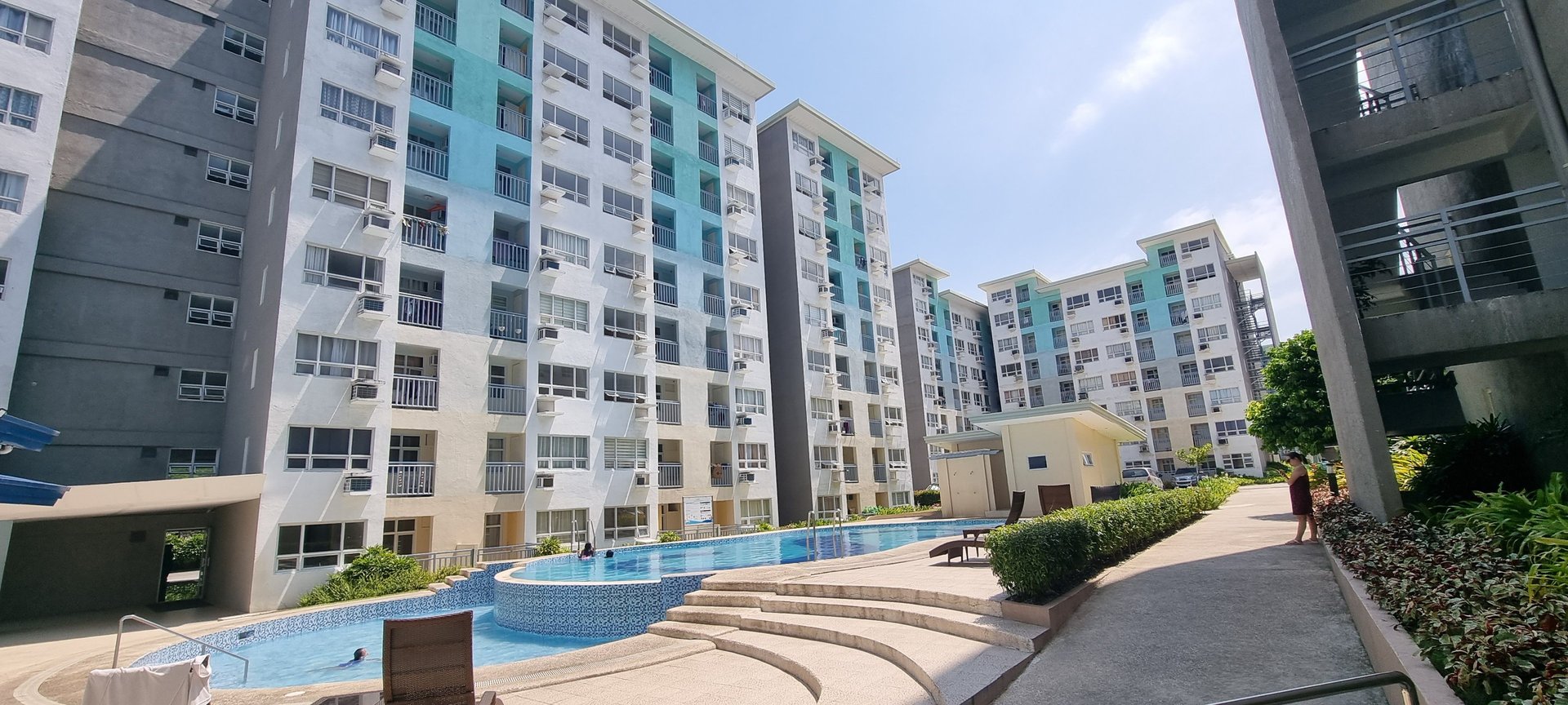an abstract photo of a curved building with a blue sky in the background