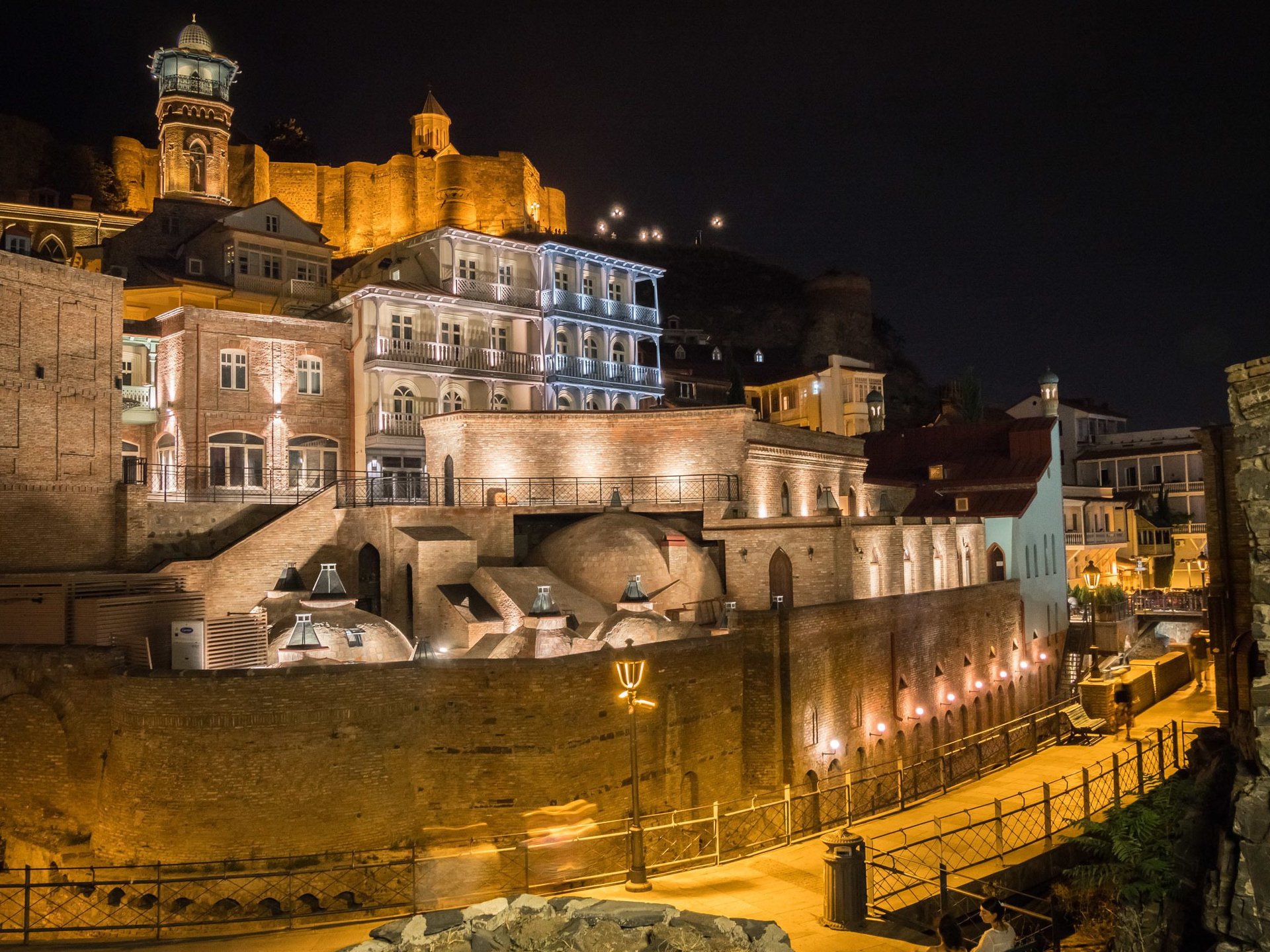 an abstract photo of a curved building with a blue sky in the background