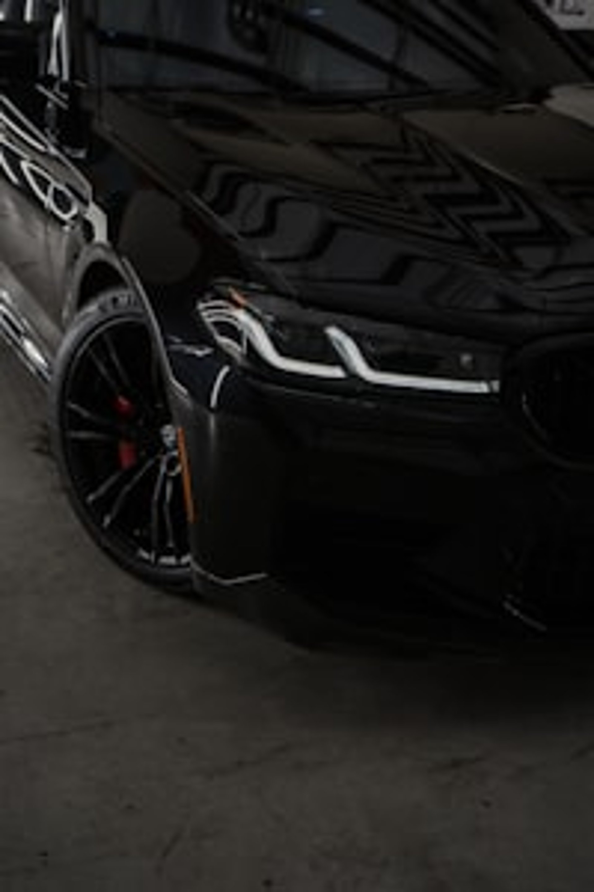 "Black Japanese import car driving on the road of UK."