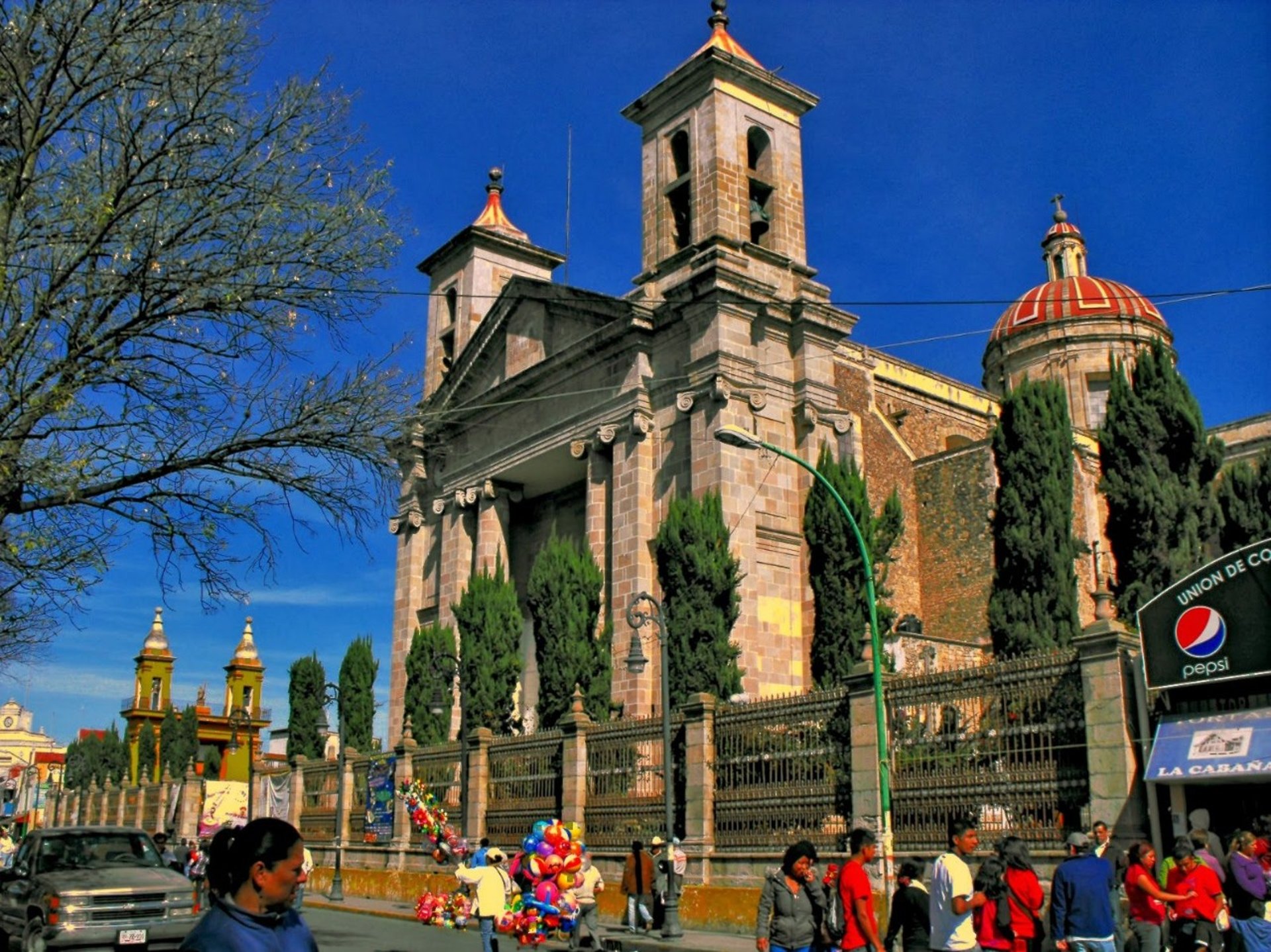 woman wearing yellow long-sleeved dress under white clouds and blue sky during daytime