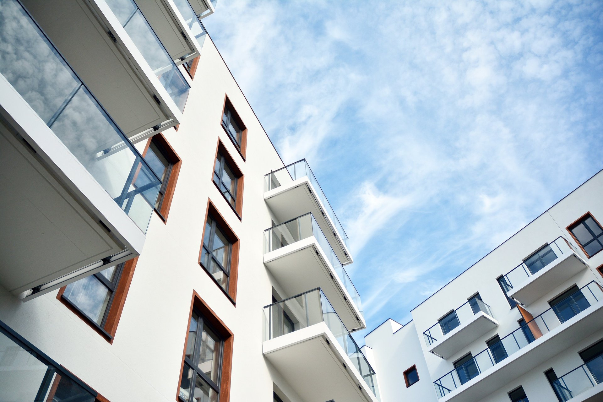 an abstract photo of a curved building with a blue sky in the background