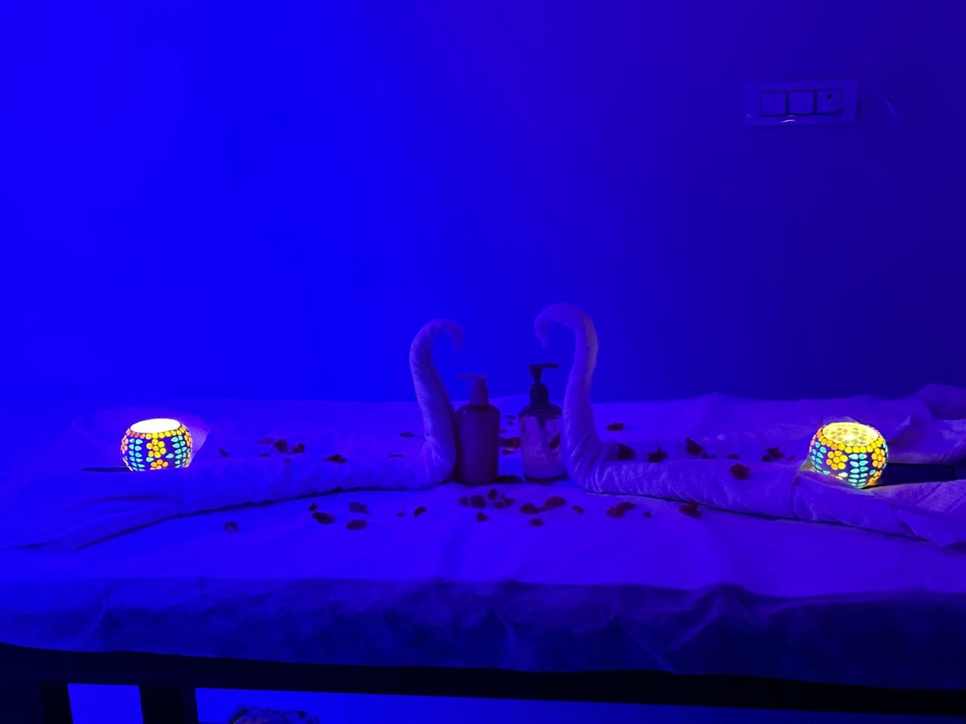 a woman laying on a bed with hot stones on her back