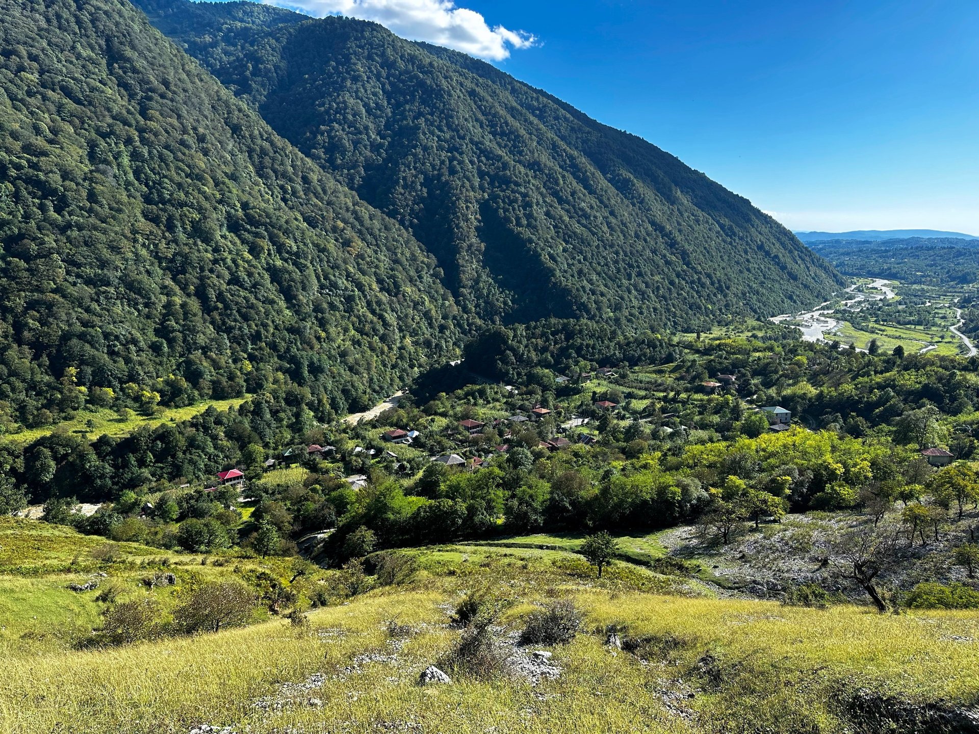 an abstract photo of a curved building with a blue sky in the background