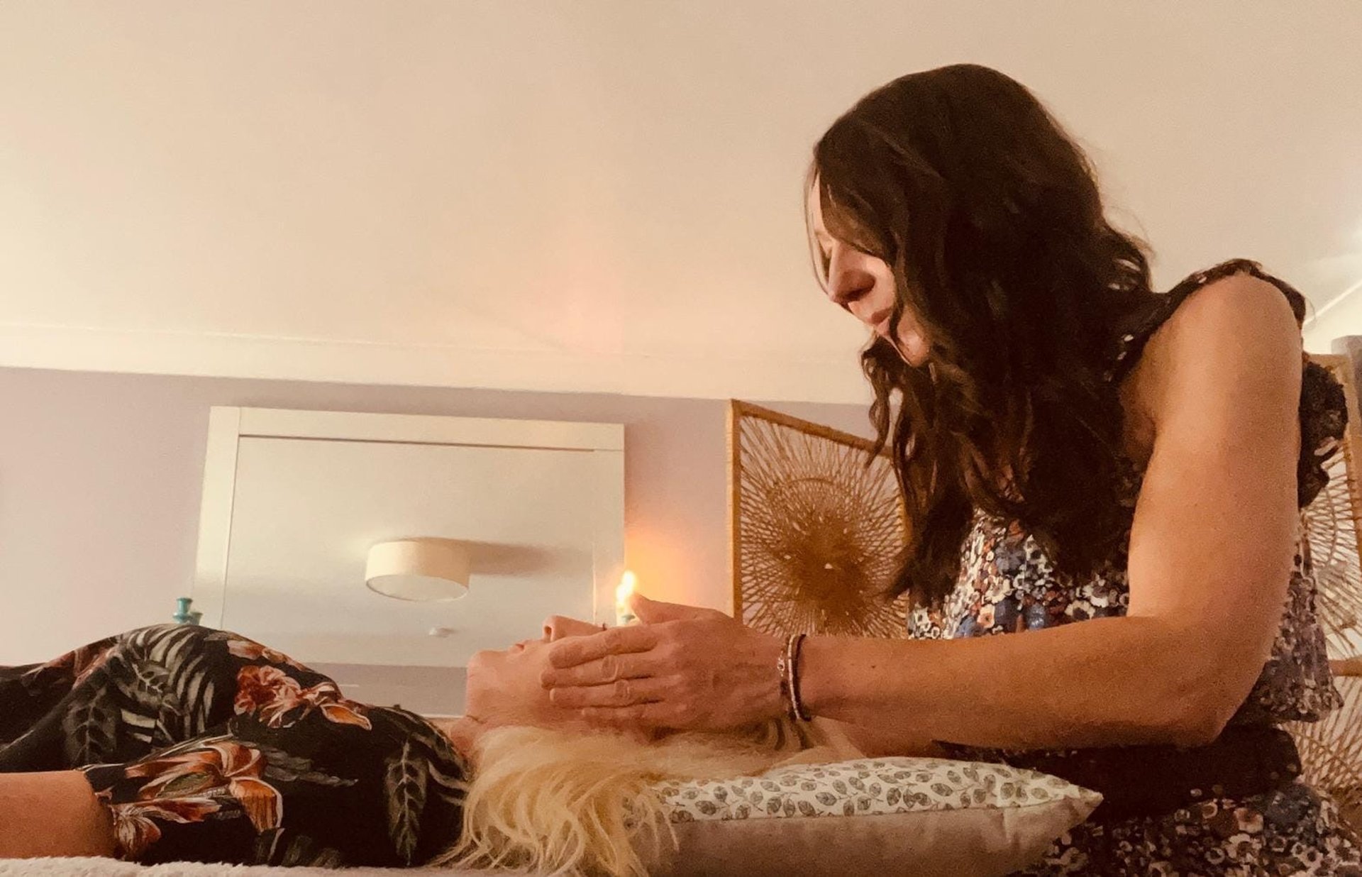 Liv giving reiki to a lady; her hands around her head