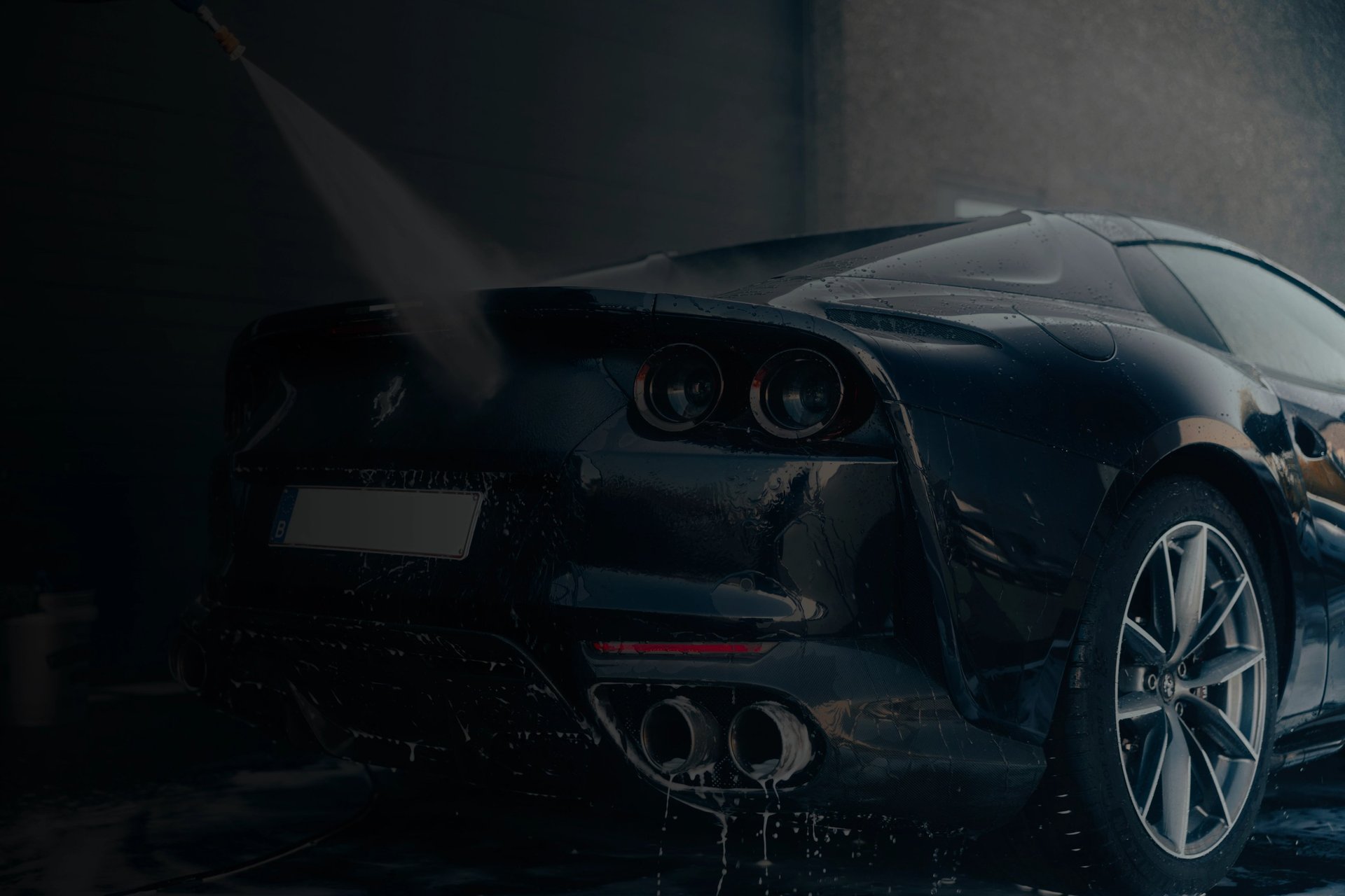 a car being washed with a high pressure washer