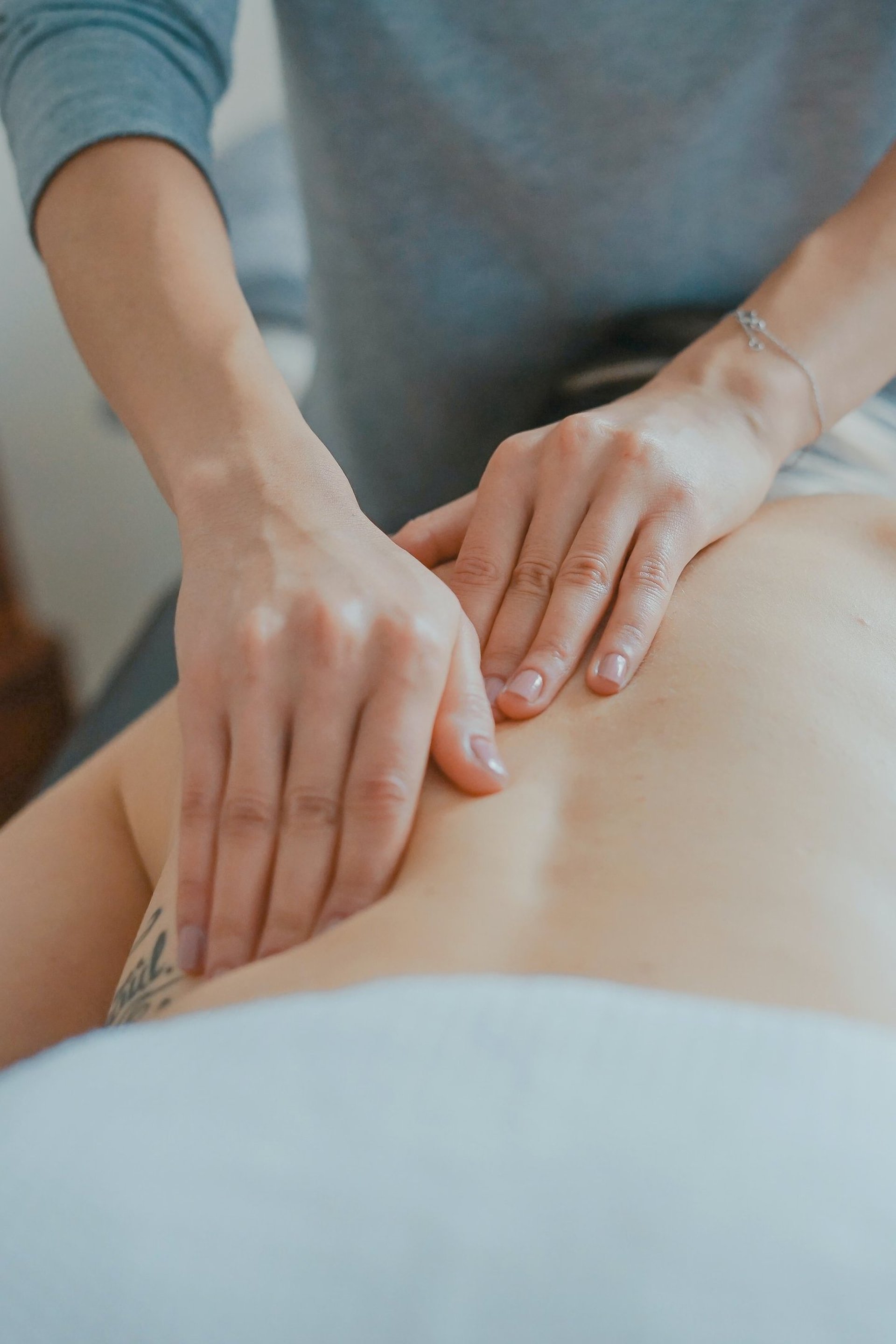 Massage therapist giving a back massage.