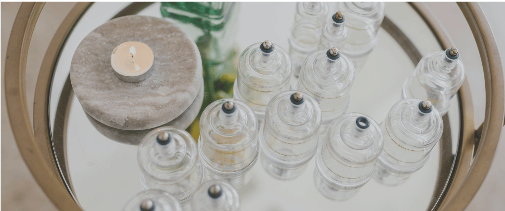 clear glass bottle on brown wooden table