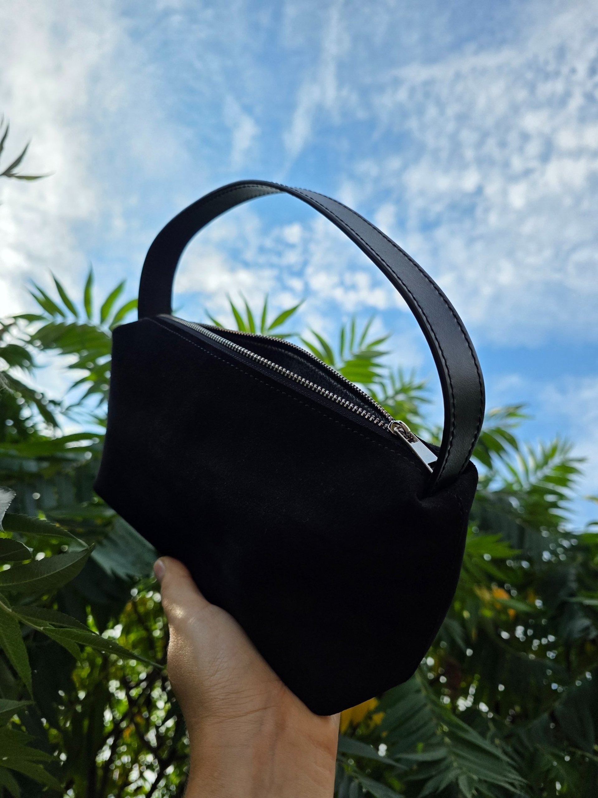 Mini black suede leather bag with a nappa leather top handle. Zipper closure, smoothly running zipper.
