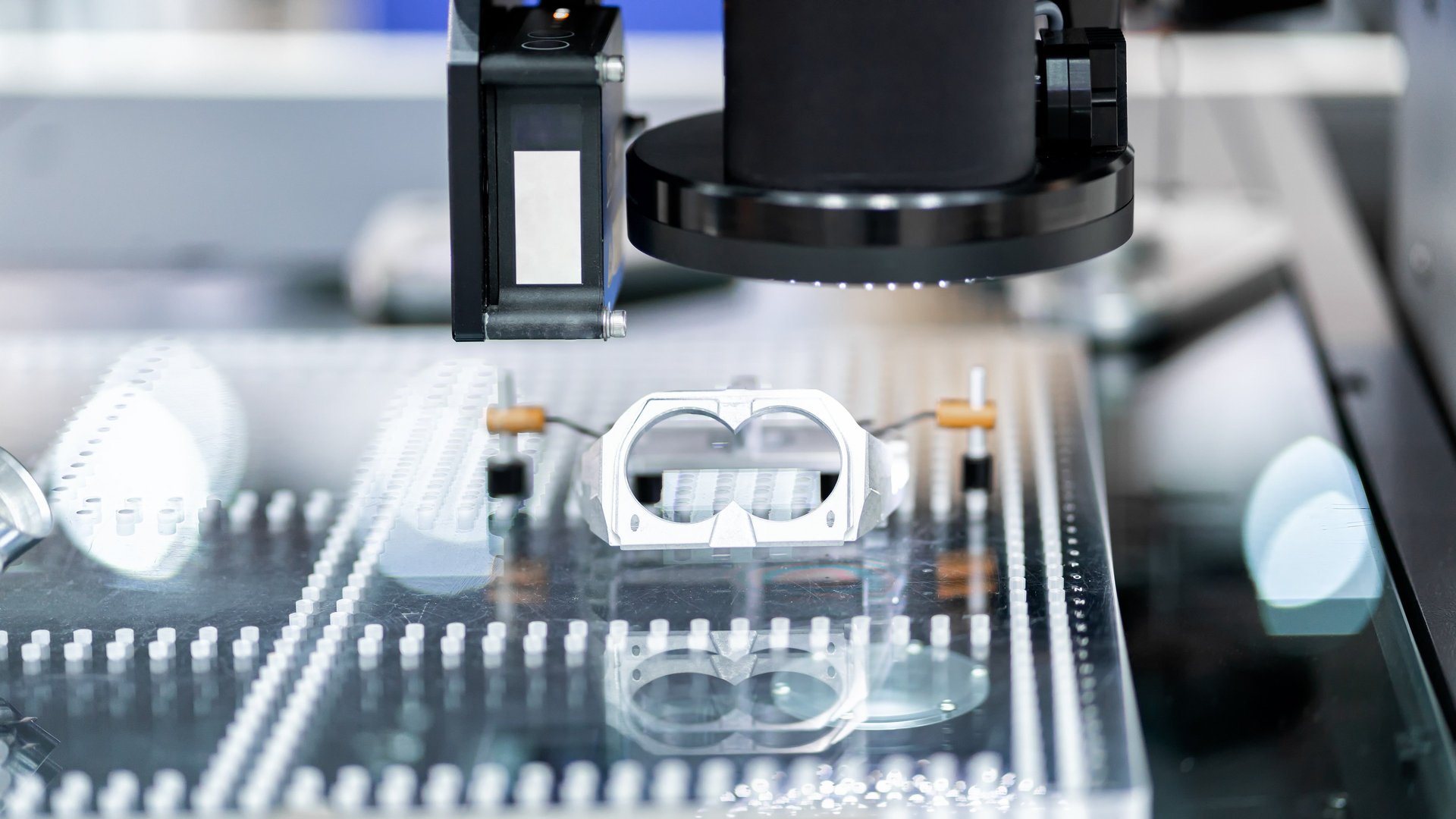 Optical CMM inspecting a fixtured component using vision and laser distance sensors.