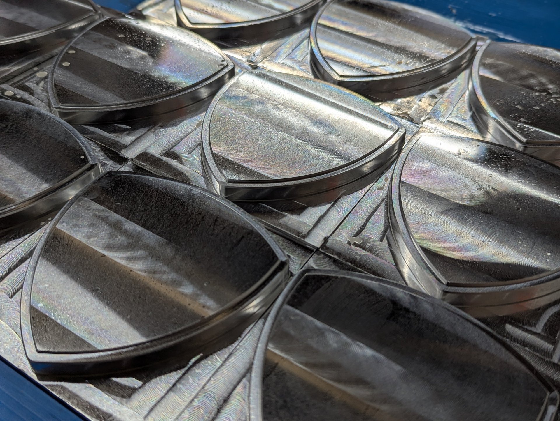 an abstract photo of a curved building with a blue sky in the background