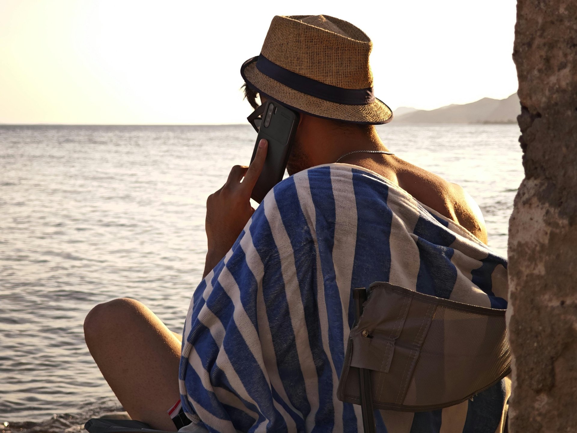 man using smartphone on chair