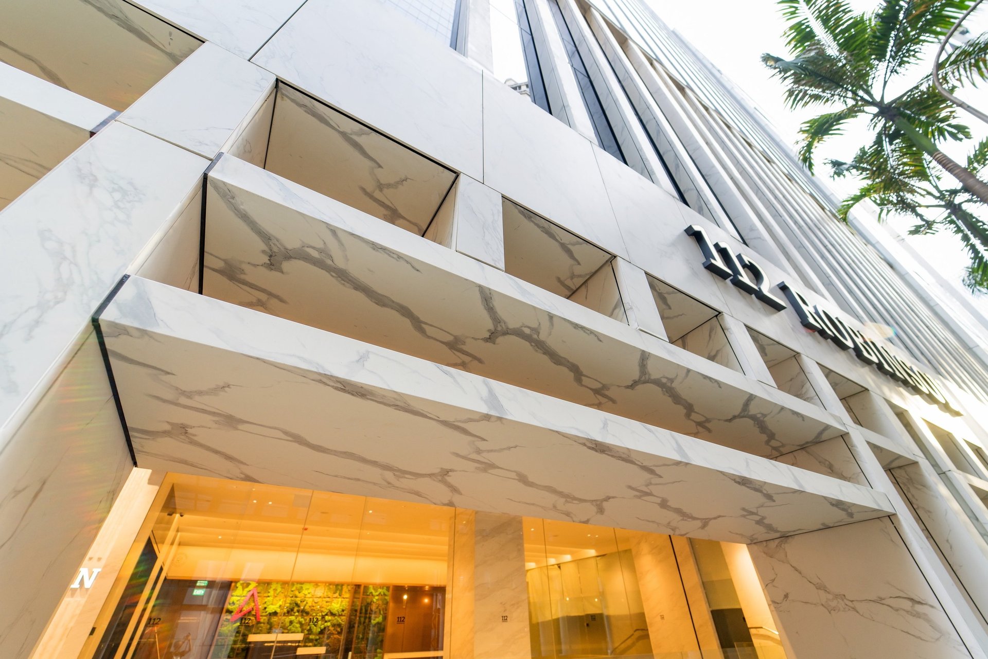 an abstract photo of a curved building with a blue sky in the background