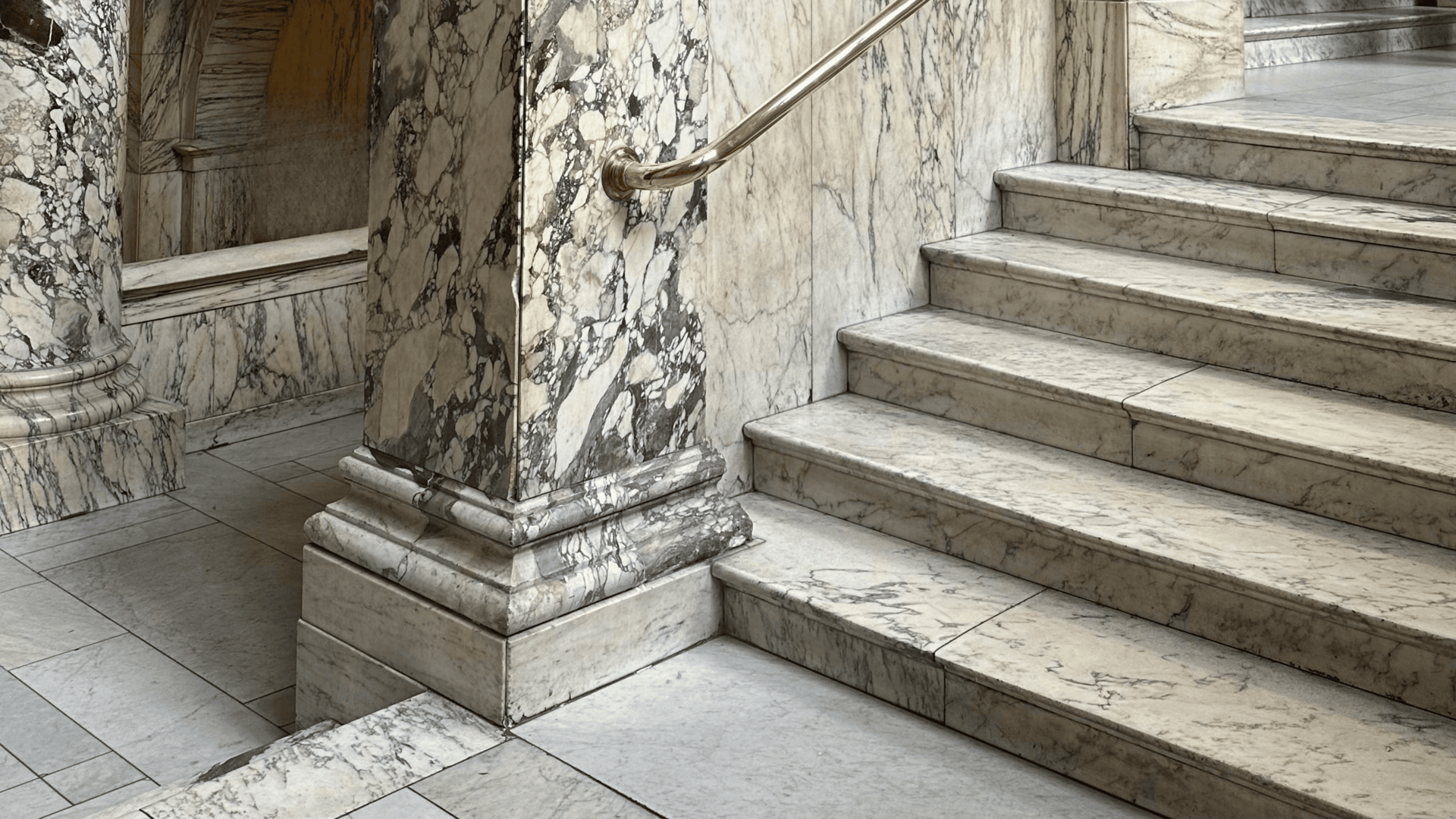 an abstract photo of a curved building with a blue sky in the background
