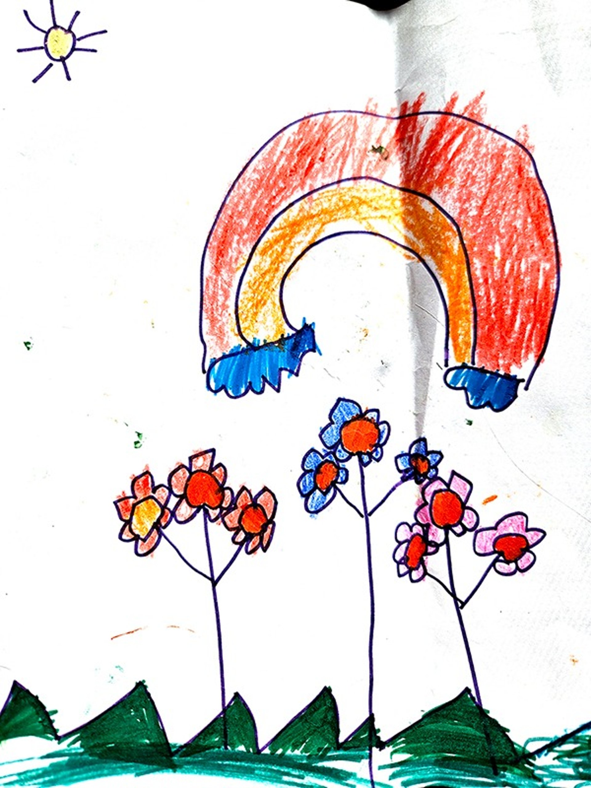 Artist's hand smudging charcoal on paper