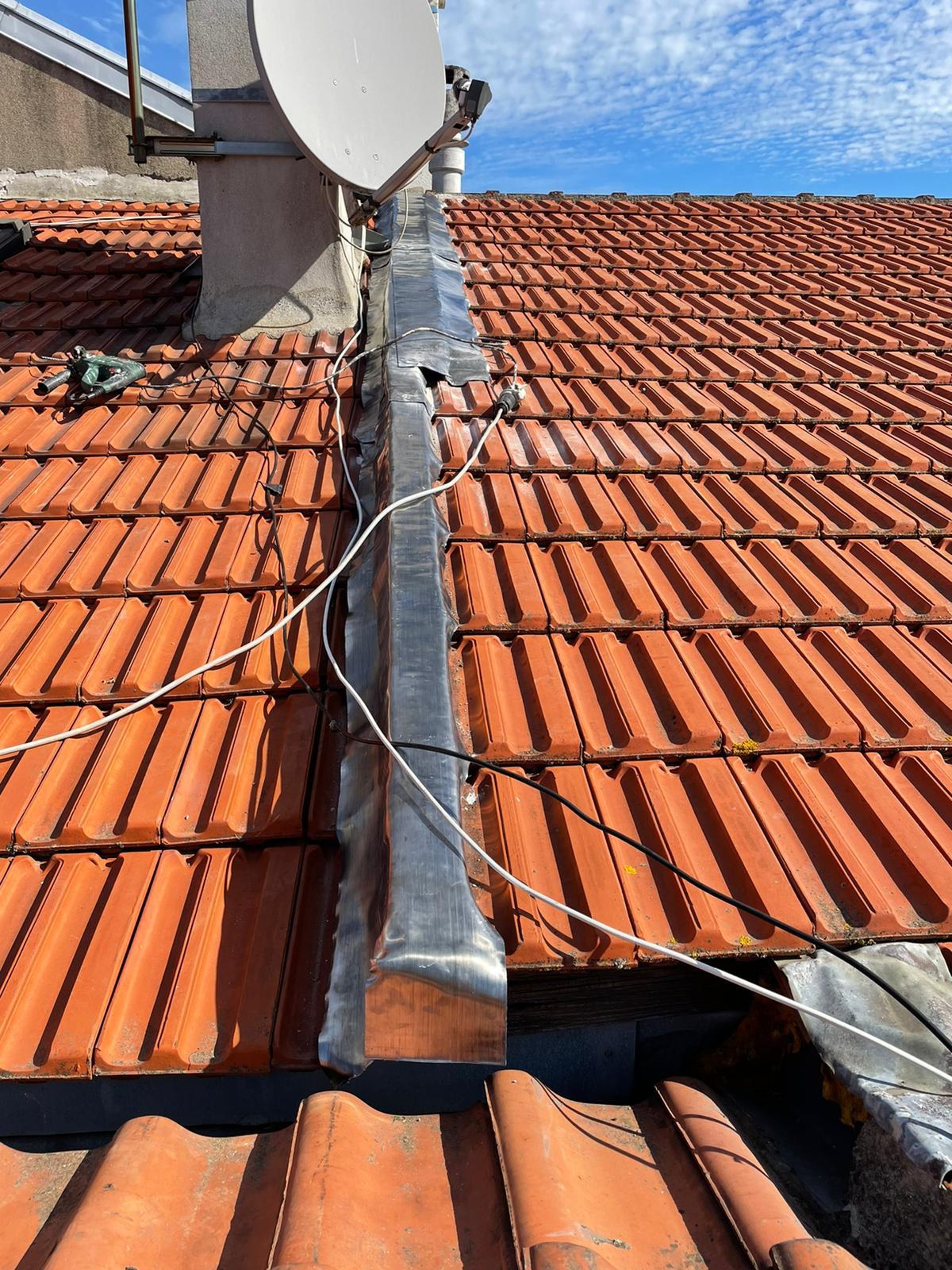 a person wearing blue gloves and holding a hammer