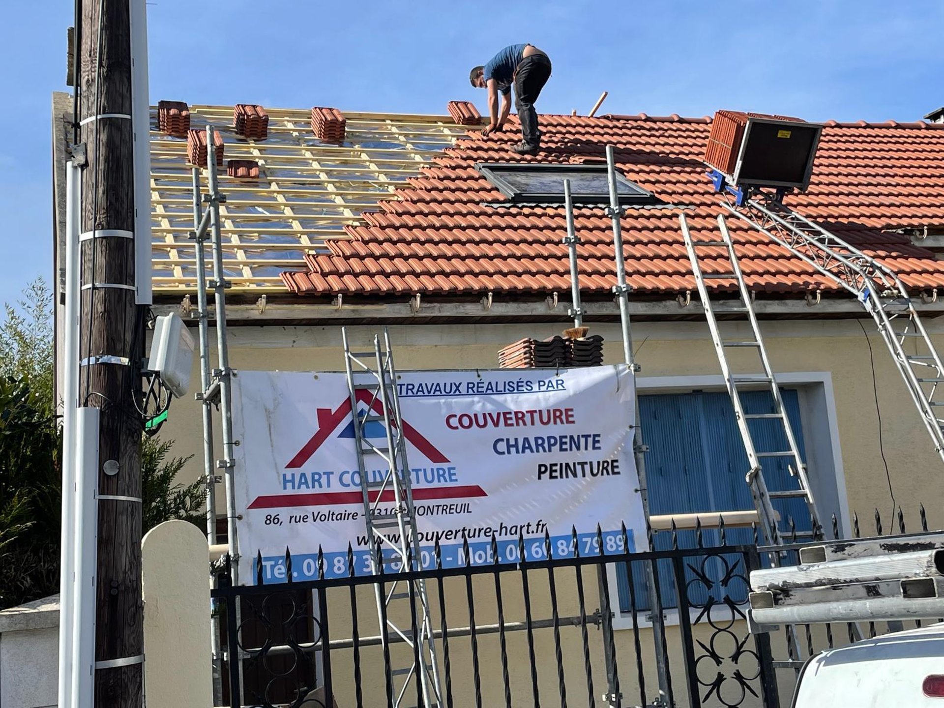 a person wearing blue gloves and holding a hammer