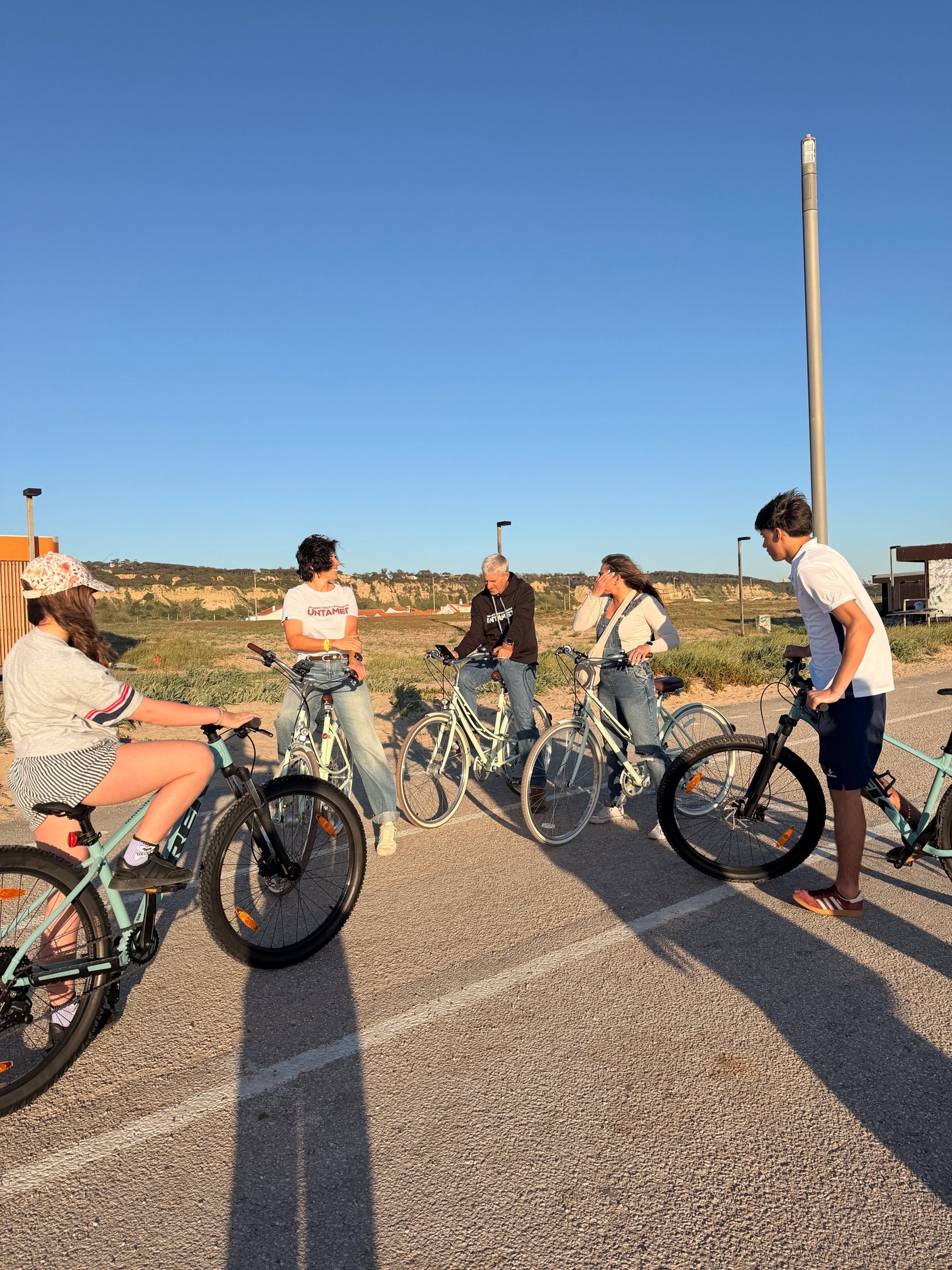 blue city bike on wooden fence near sea during daytime