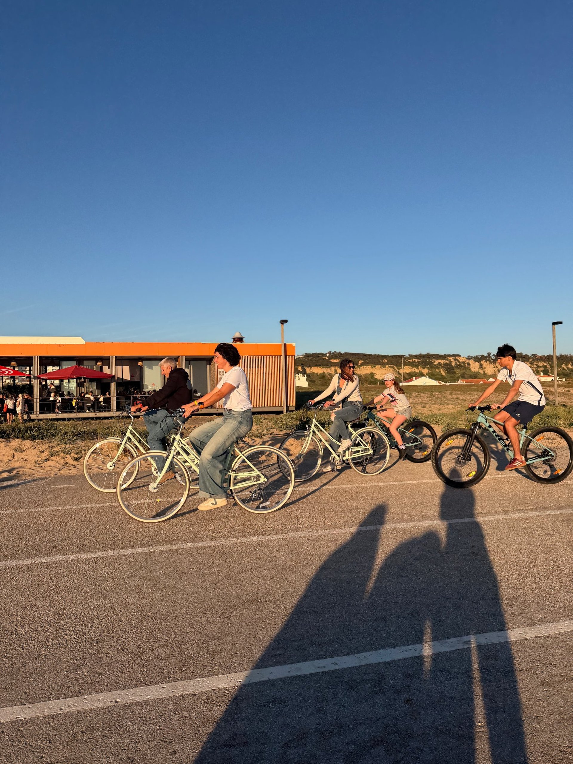 man in red shirt riding bicycle on road during daytime