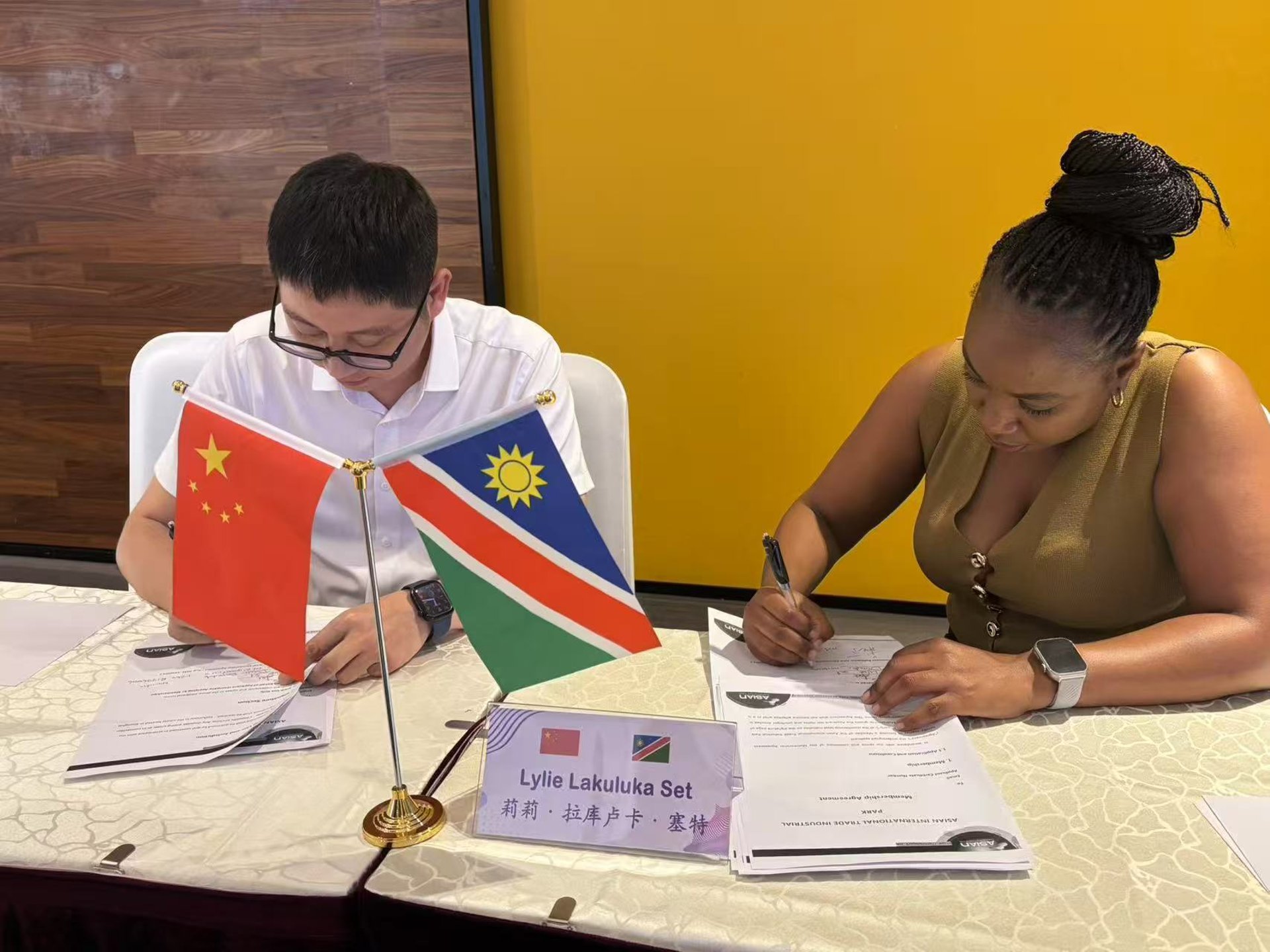 A man sanding a wooden table with a sander
