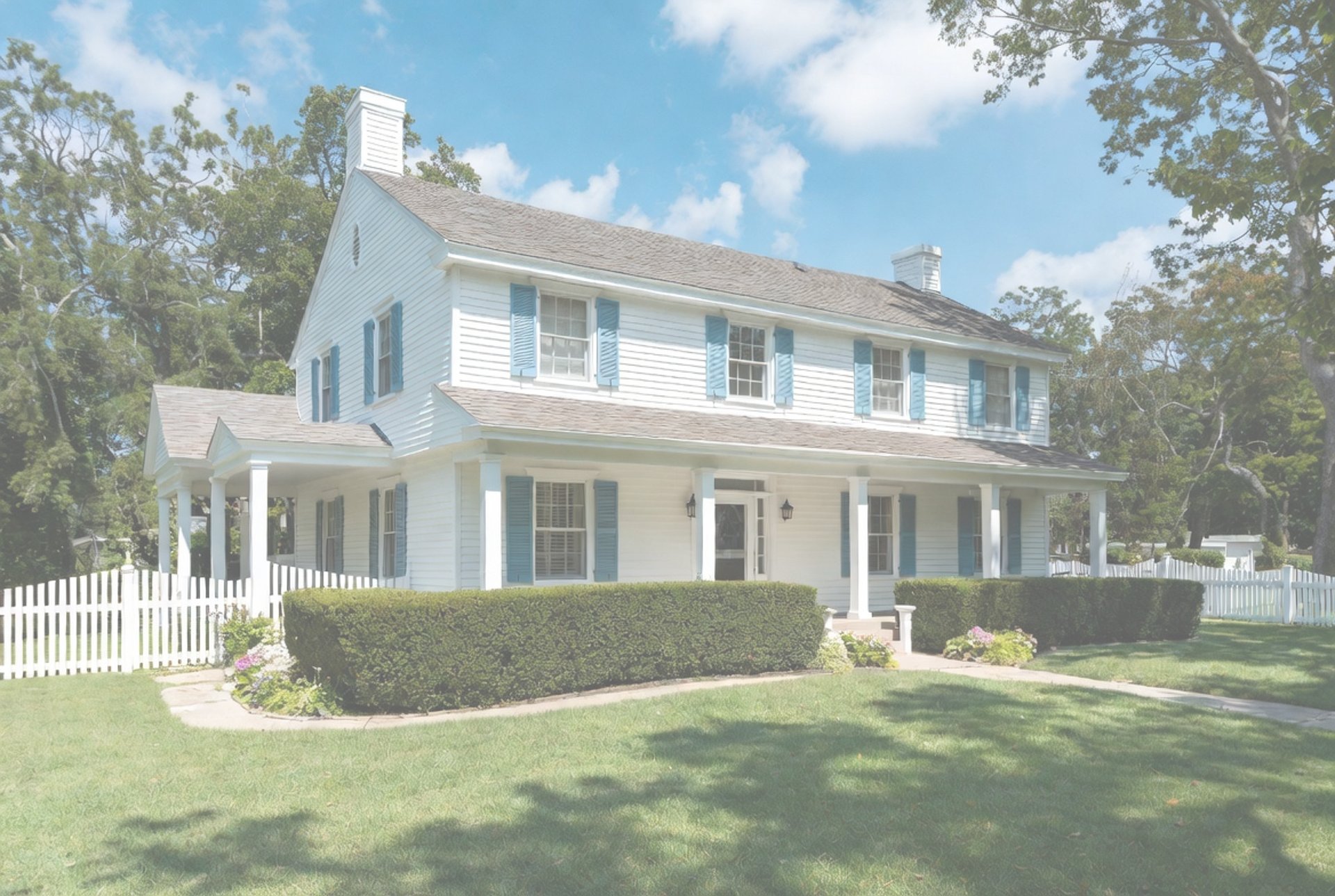 brown and white concrete house near green grass field during daytime