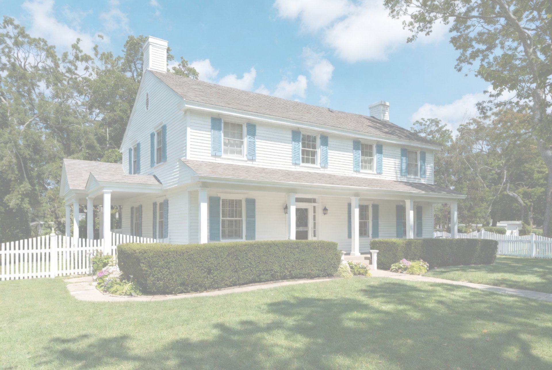 brown and white concrete house near green grass field during daytime